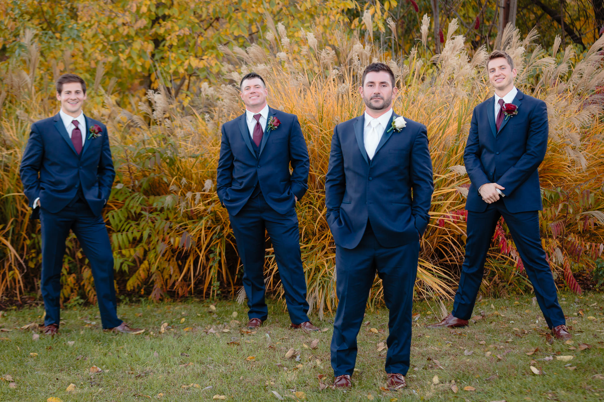 Groomsmen pose in navy tuxes from Jack's Tuxedo before a Riverside Landing wedding