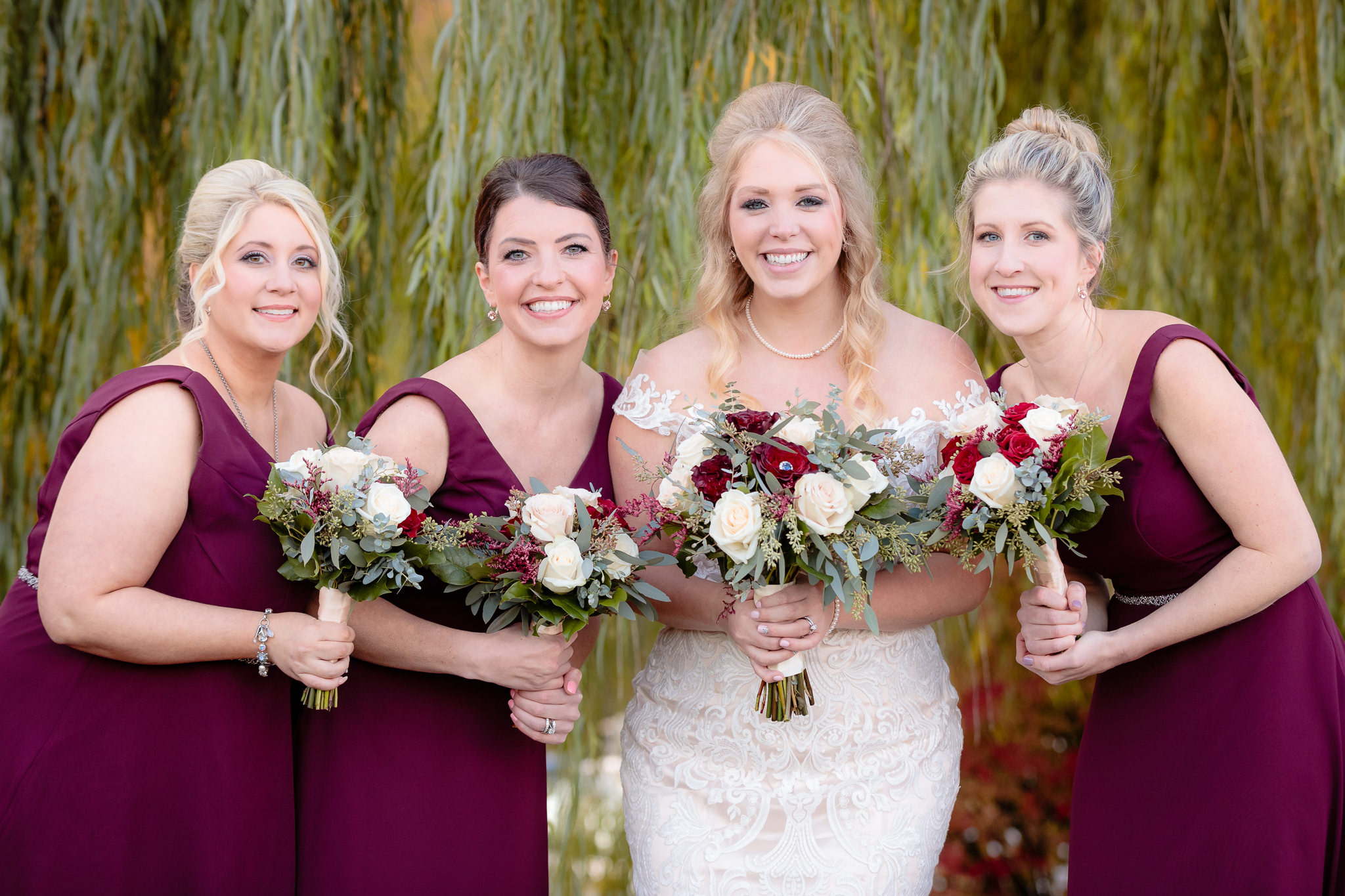 Bride with her bridesmaids in burgundy Morilee dresses from MB Bride
