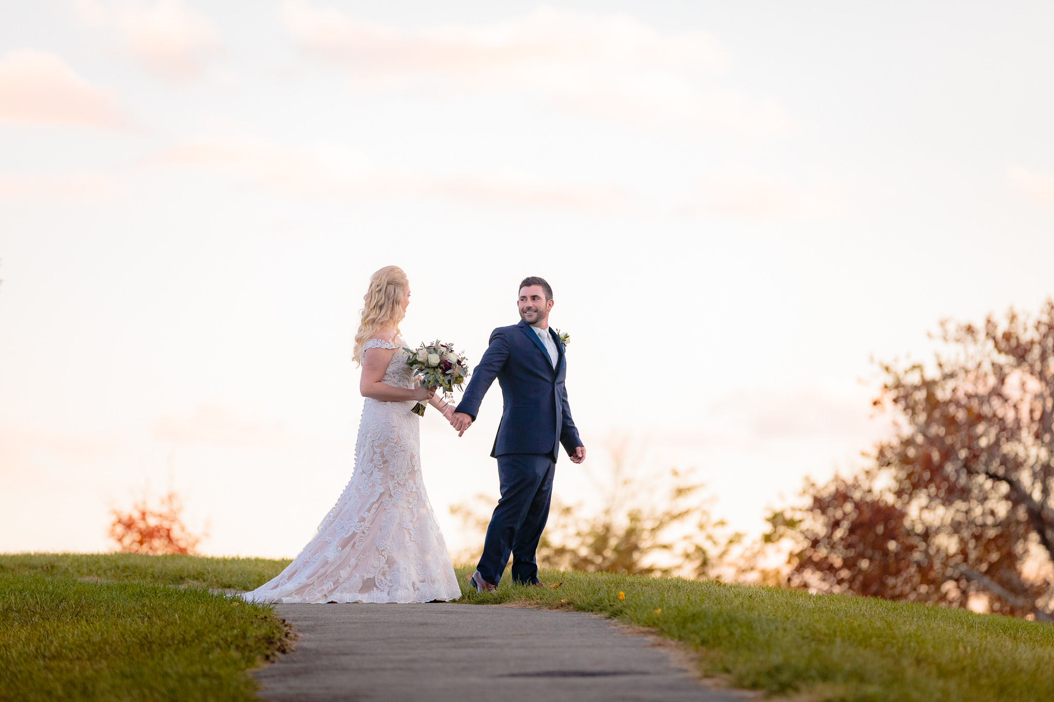 Golden hour portraits at the top of a hill before a Riverside Landing wedding reception