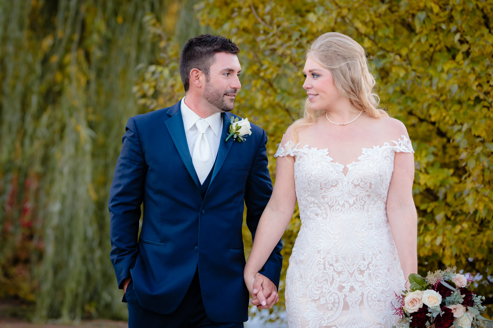 Bride and groom walk together to their Riverside Landing wedding reception