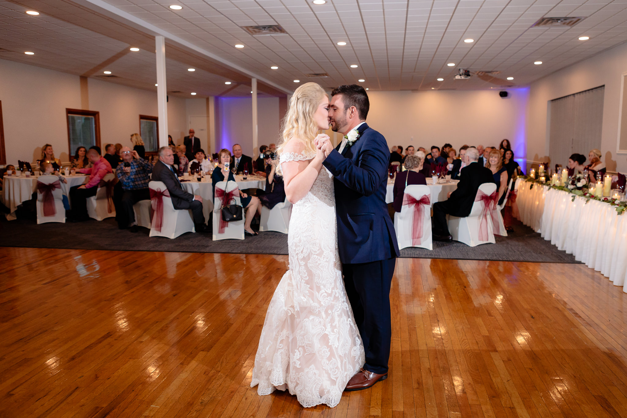 Bride and groom kiss during their first dance at Riverside Landing
