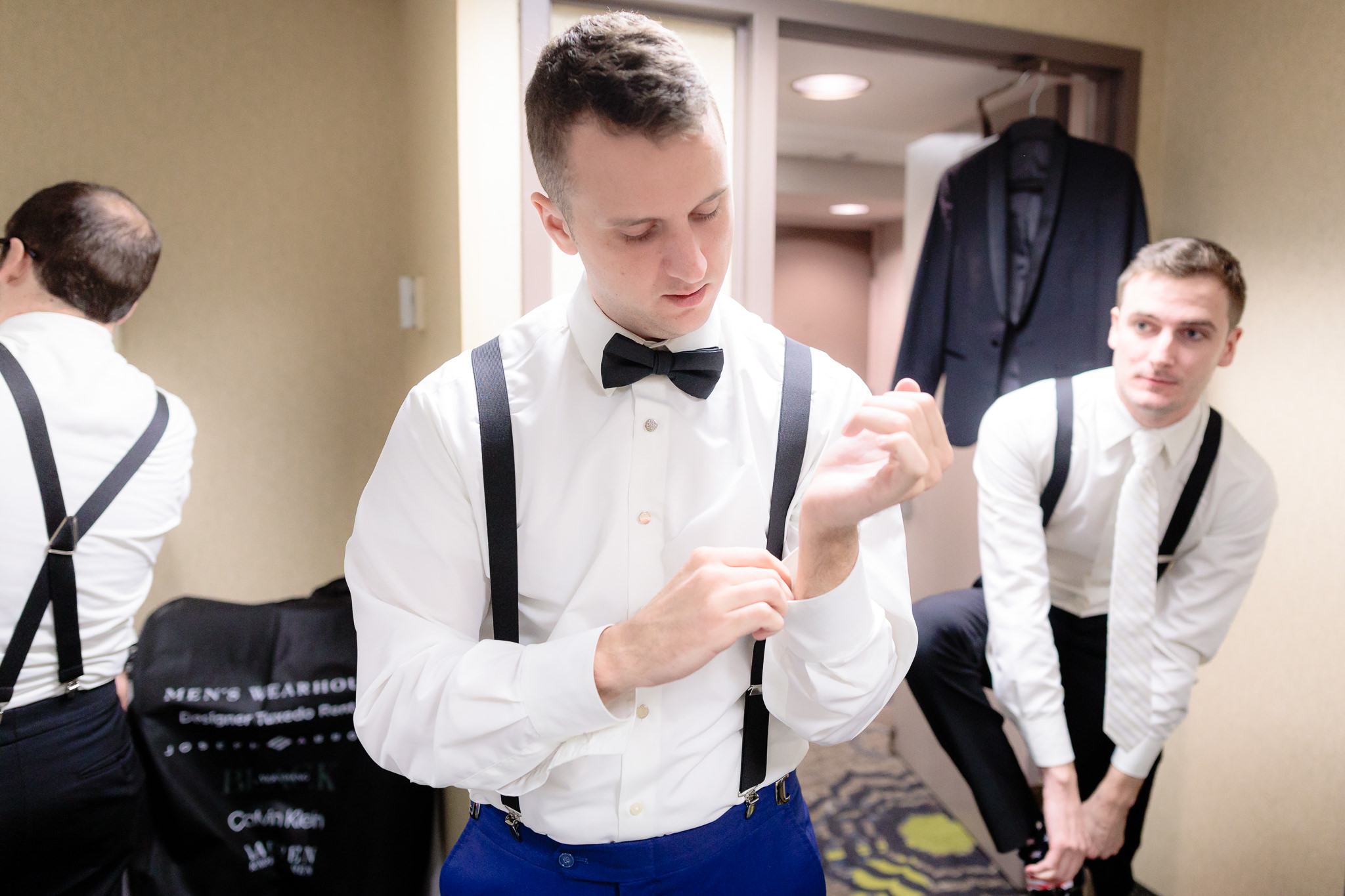 Groom fastens his cufflink before his Saint Paul Cathedral wedding