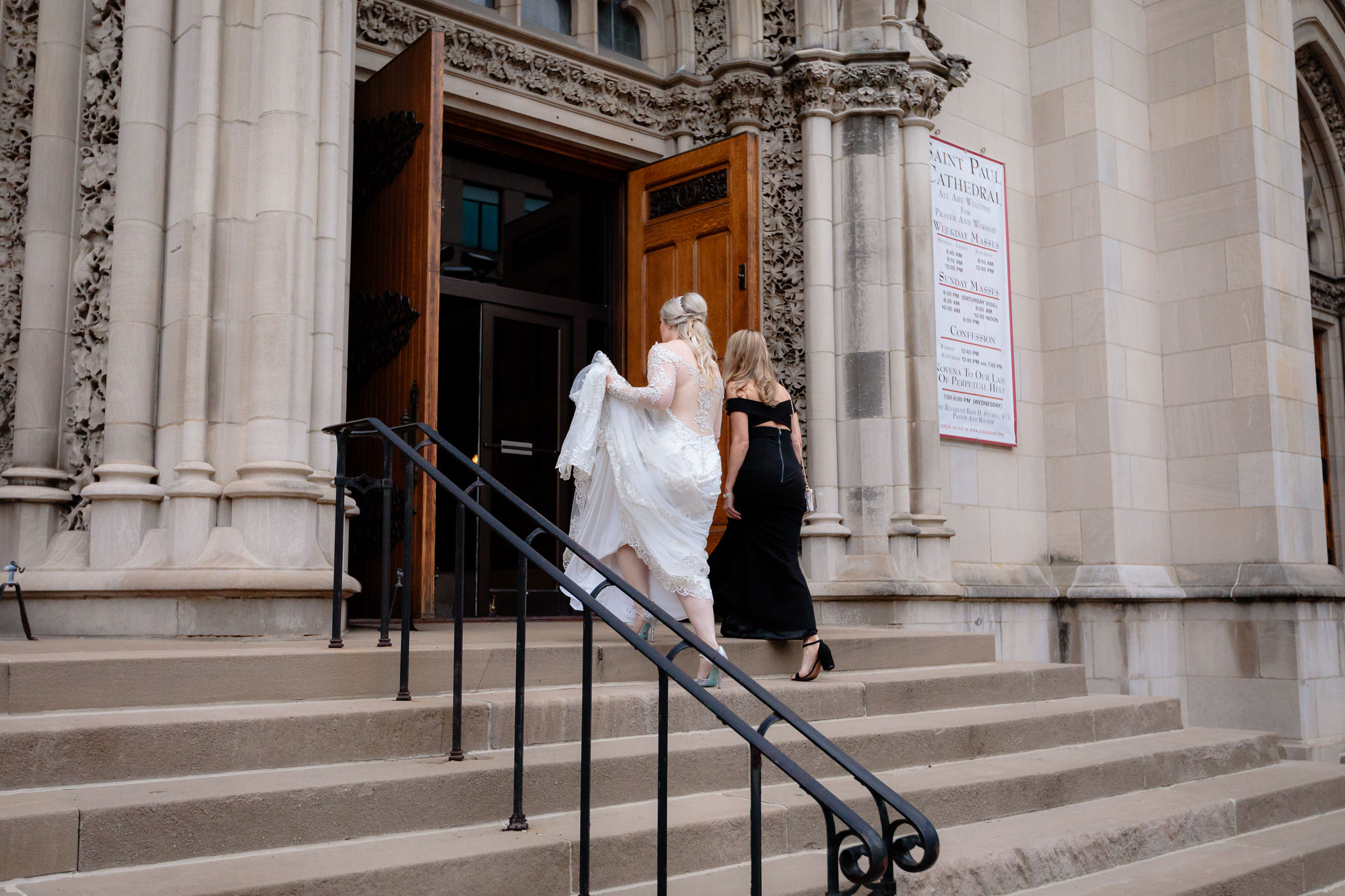 Bride & bridesmaid enter Saint Paul Cathedral for a wedding ceremony