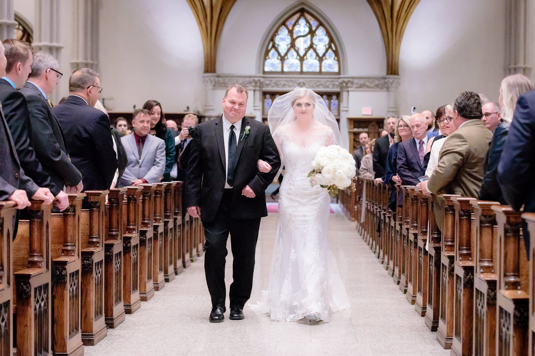 Bride walks down the aisle of Saint Paul Cathedral with her father