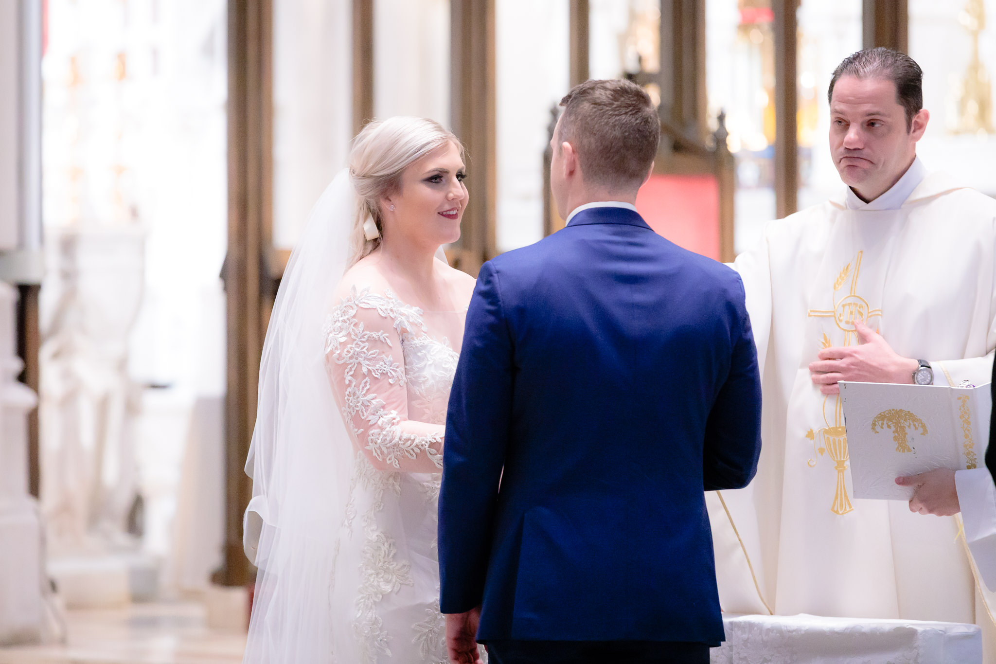 Bride smiles at her groom during a Saint Paul Cathedral wedding ceremony