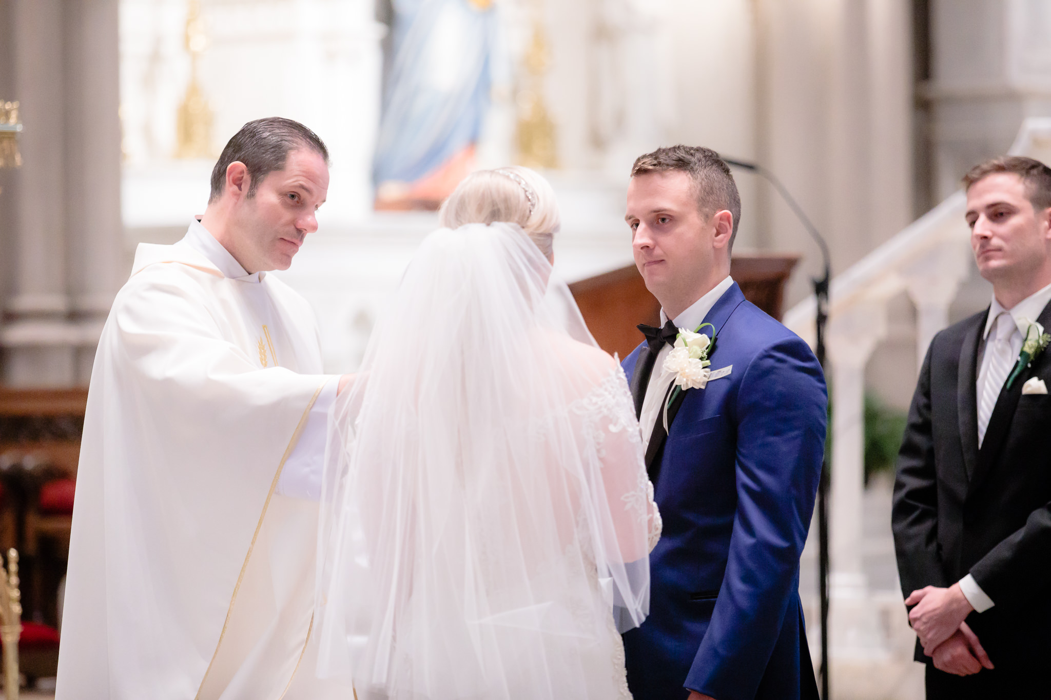 Groom listens as bride says her vows at Saint Paul Cathedral