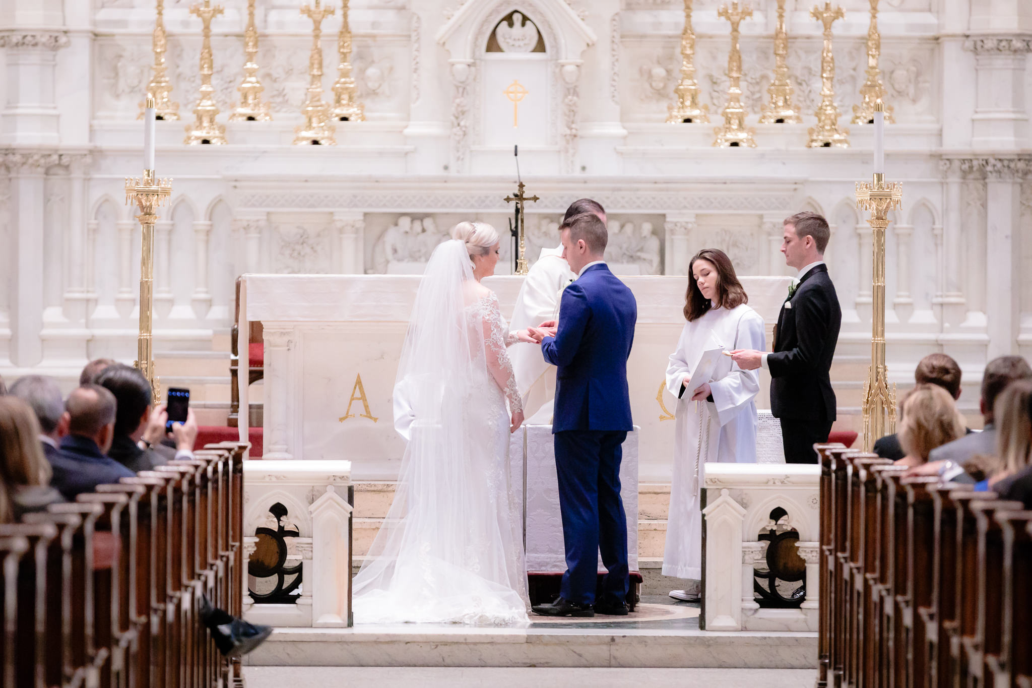Groom places the ring onto the bride's finger at Saint Paul Cathedral