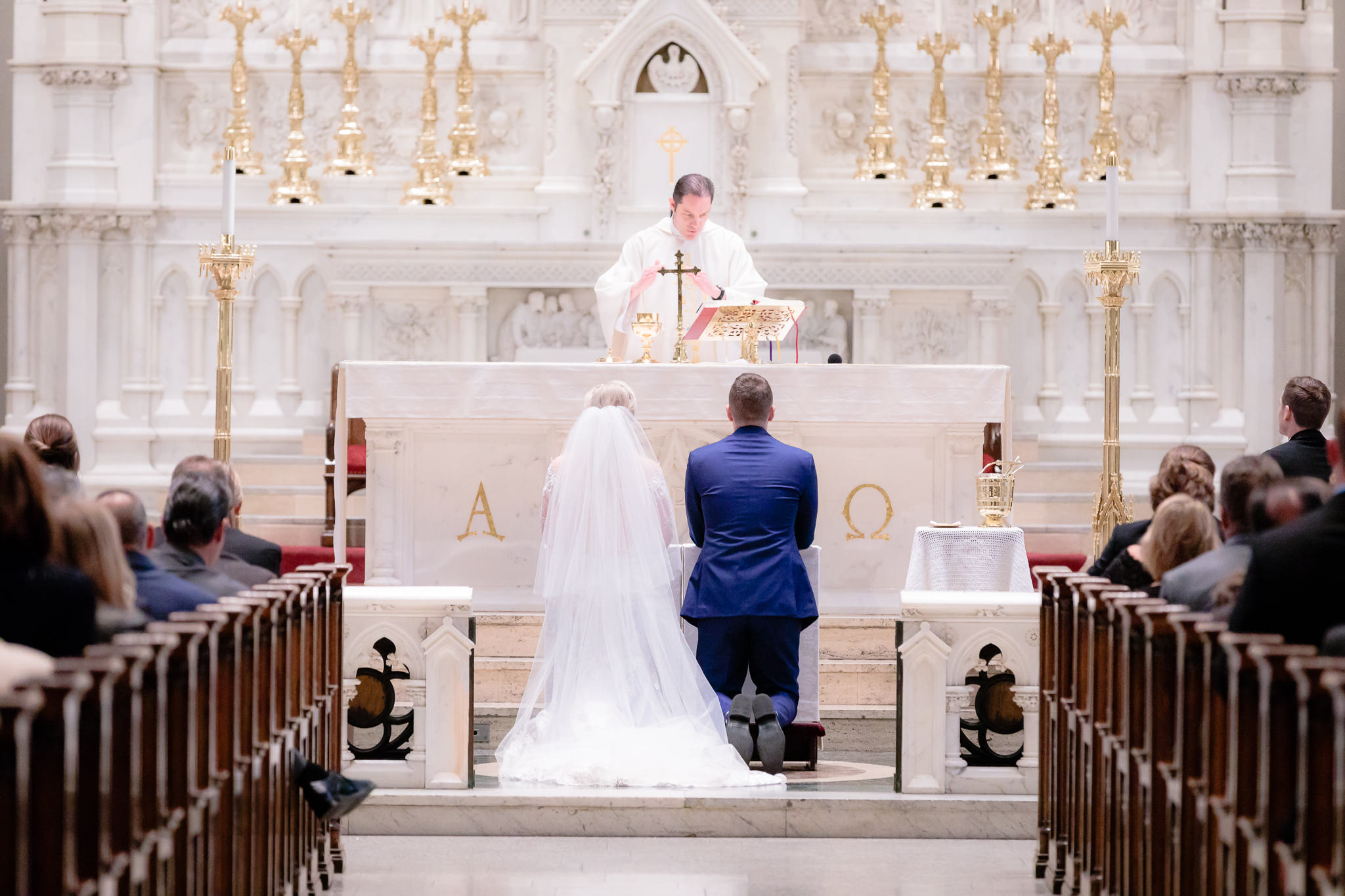 Bride & groom kneel at the altar during a Saint Paul Cathedral wedding