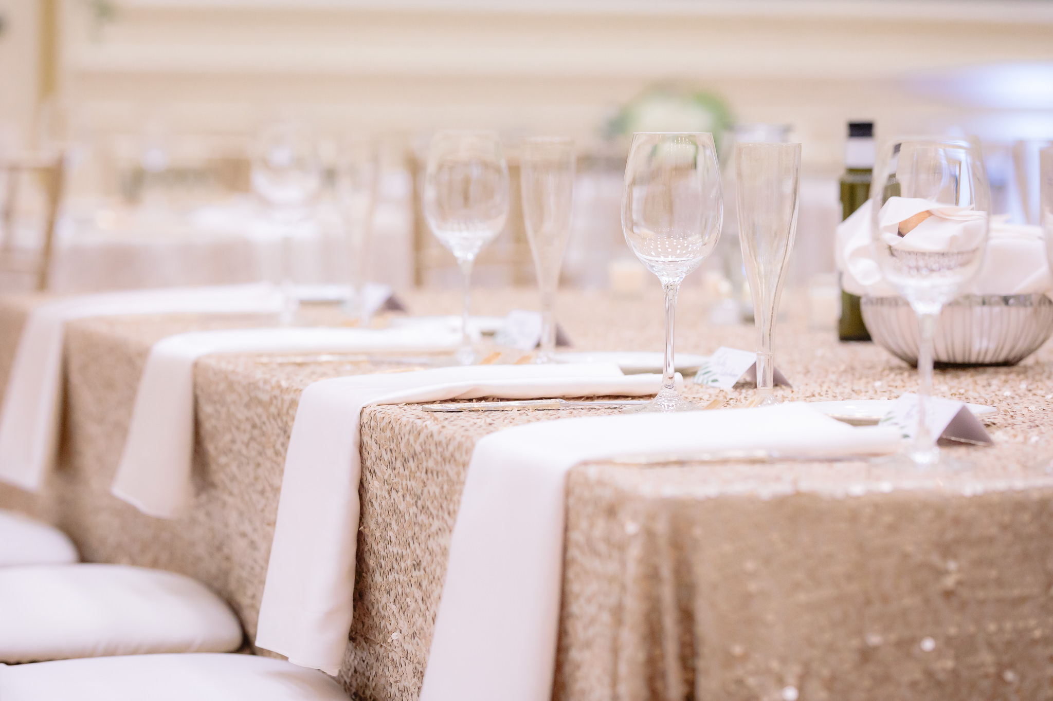 Gold sequin table cloth with white napkins at a Soldiers & Sailors wedding