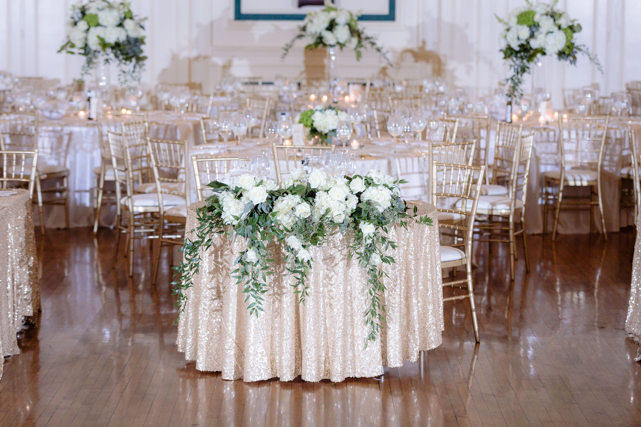 White hydrangeas and greenery drape the sweetheart table at Soldiers & Sailors Memorial Hall
