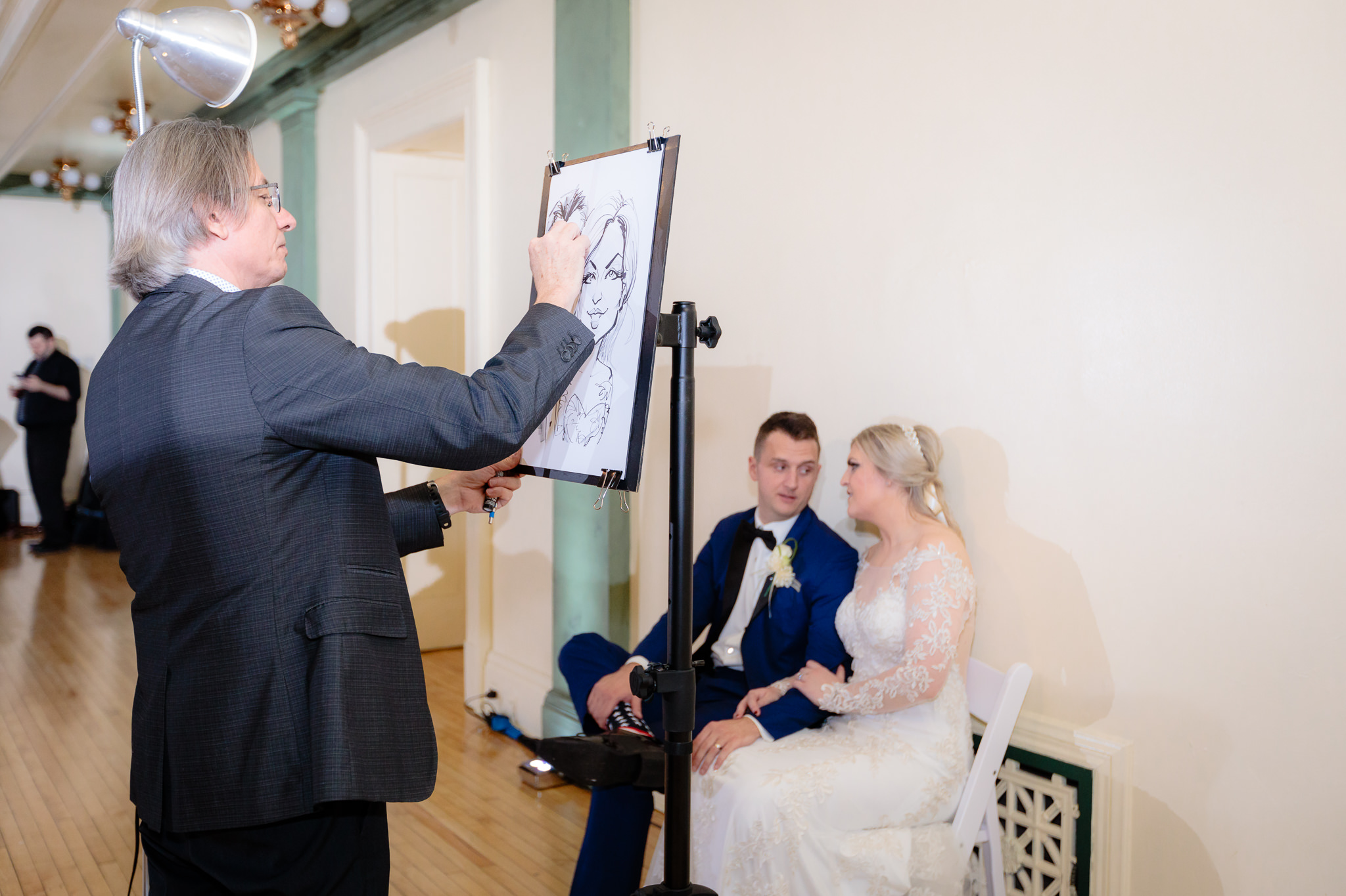 Caricature artist draws the newlyweds at their Soldiers & Sailors wedding