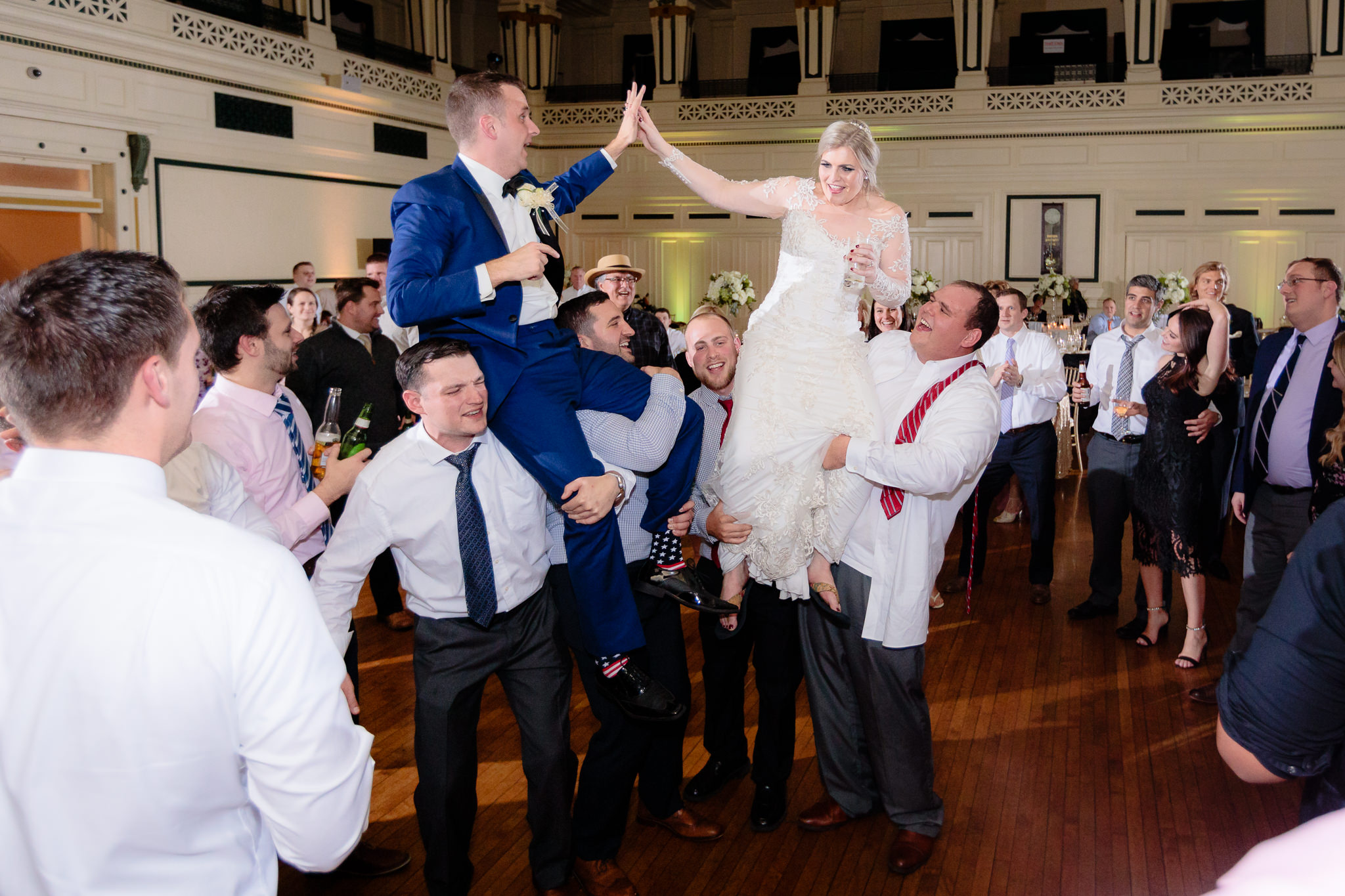 Newlyweds high five at their Soldiers & Sailors wedding