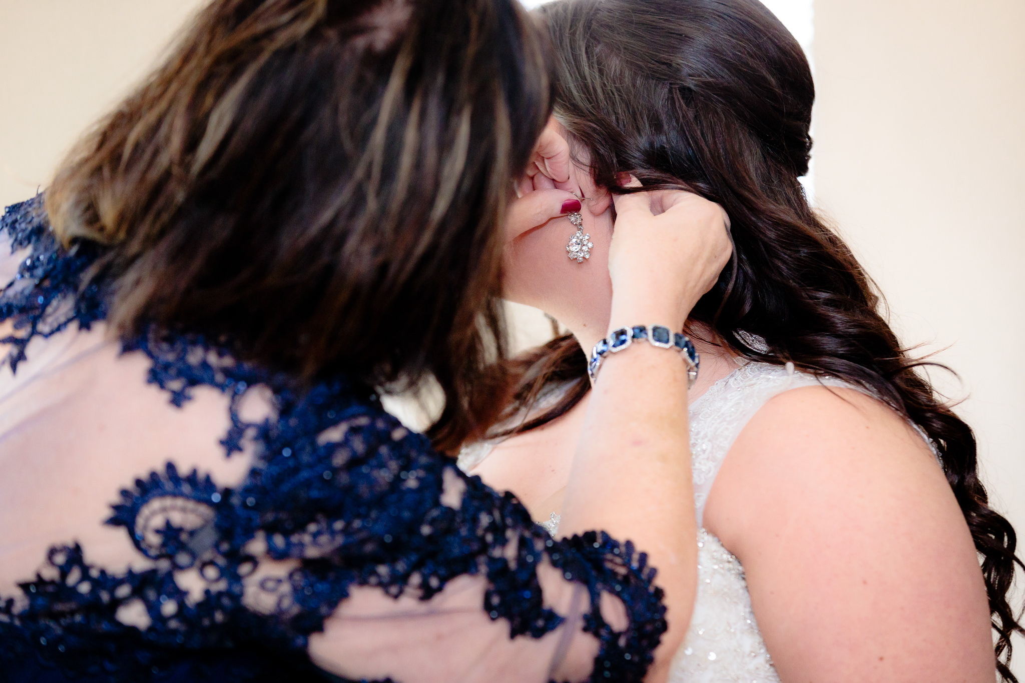 Mother of the bride helps put in bride's earrings before her wedding at St. Malachy in Kennedy Township