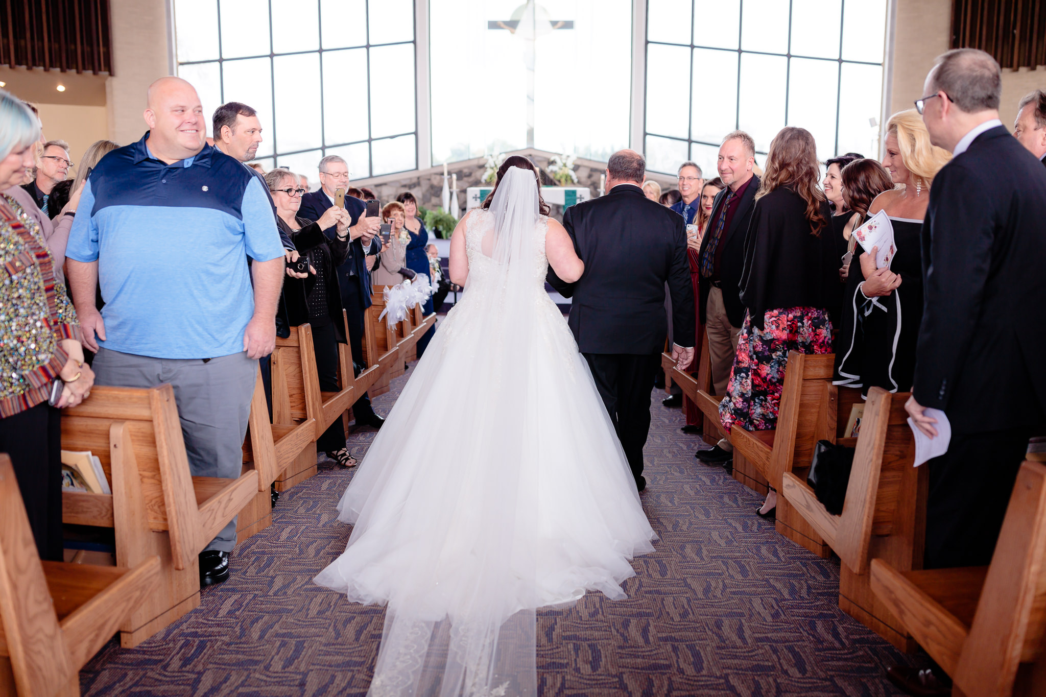 Father of the bride walks his daughter down the aisle at St. Malachy in Kennedy Township