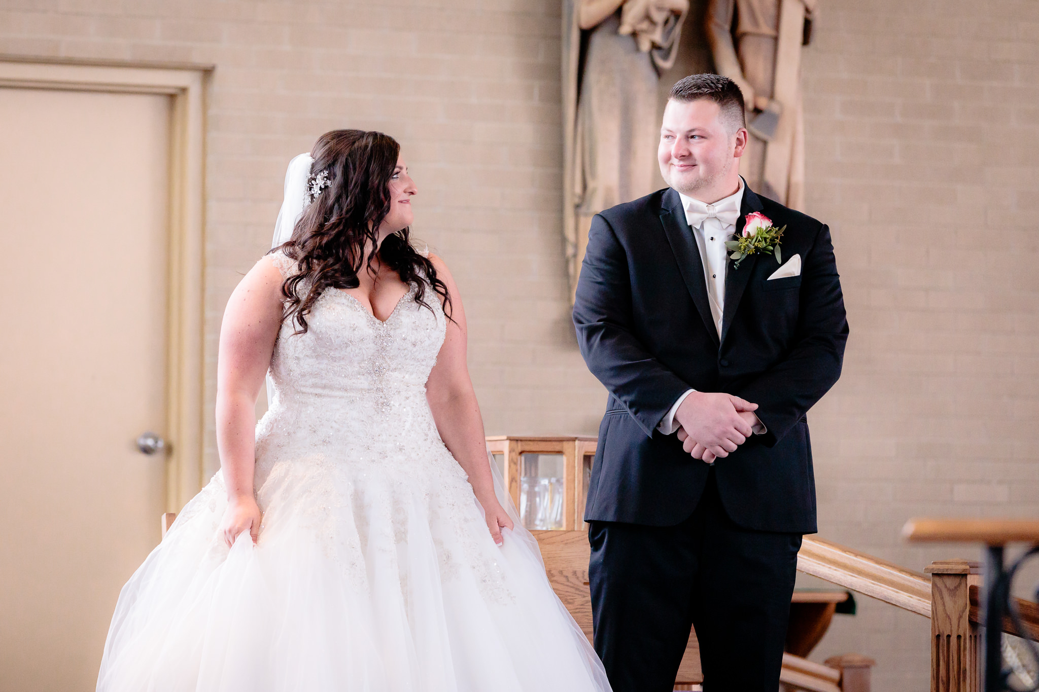 Bride and groom smile at each other during their wedding ceremony at St. Malachy