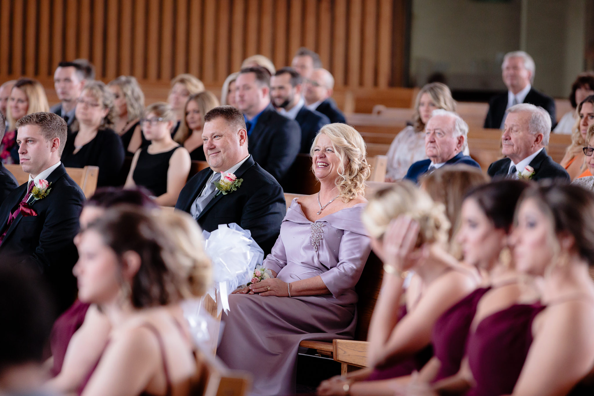 Parents of the groom laugh during the homily at a St. Malachy wedding
