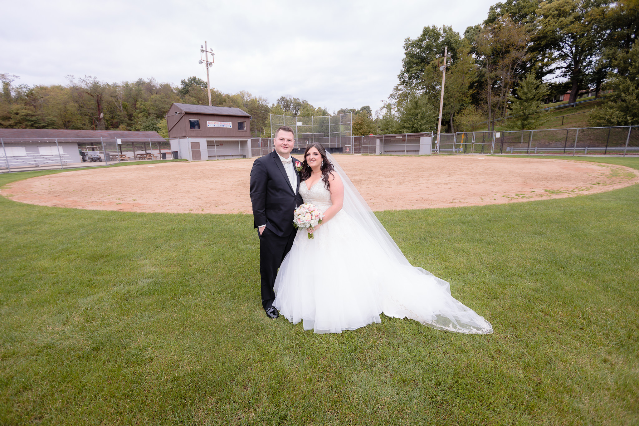 Newlyweds at the Robinson Township Girls Softball field where they met