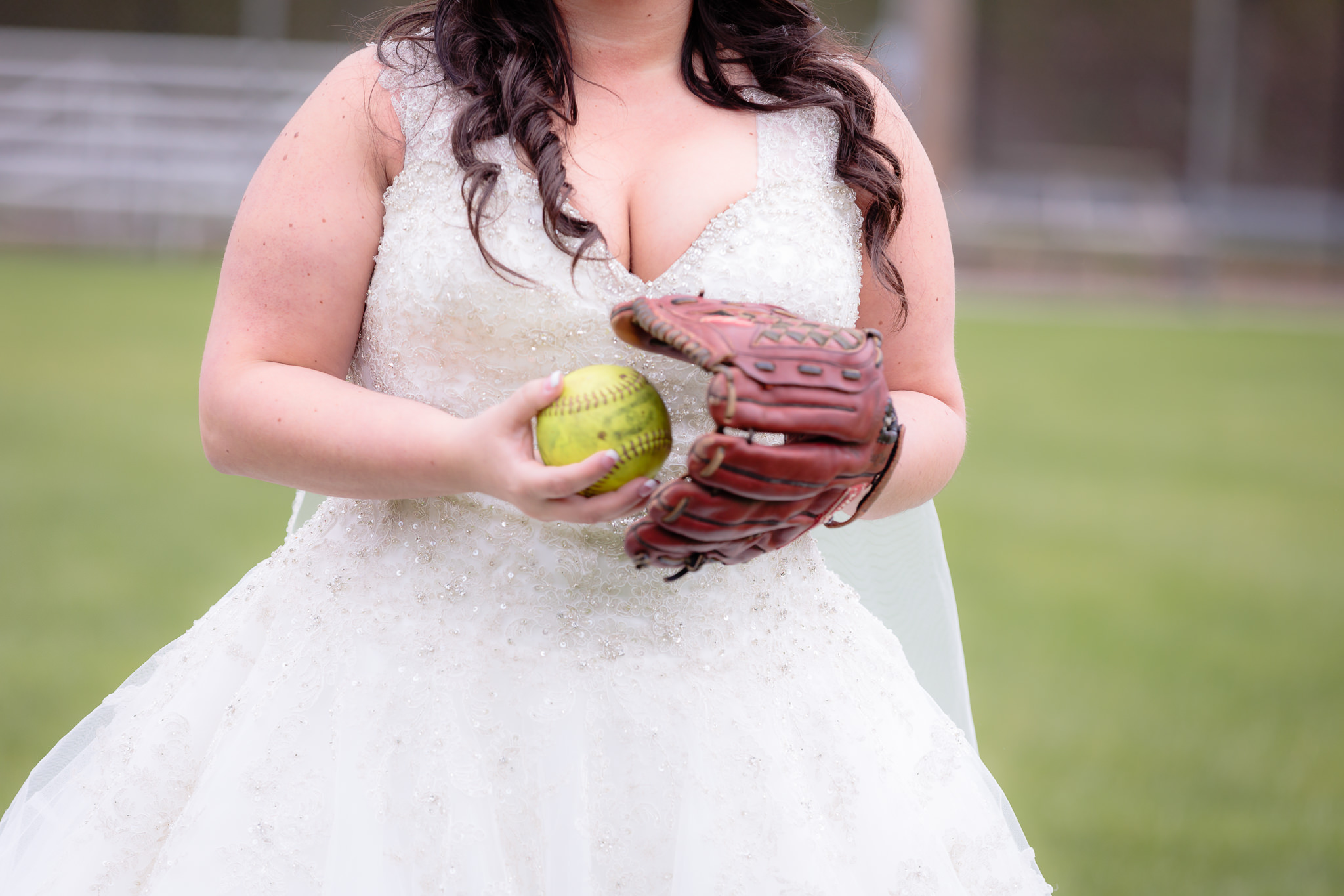 Bride tosses a yellow softball into her glove at the Robinson Township Girls Softball field