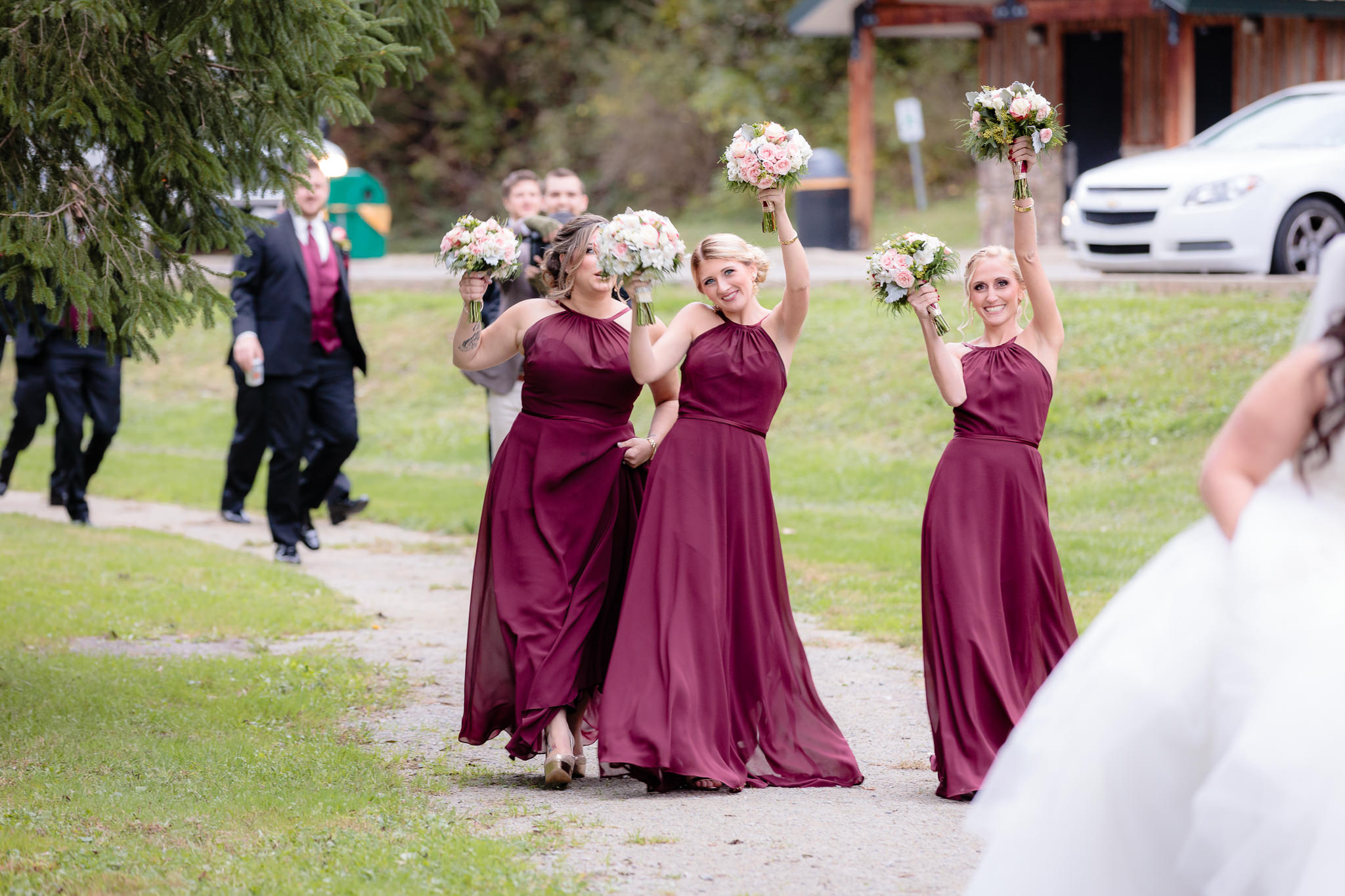 Bridesmaids cheer as they walk through Olson Park