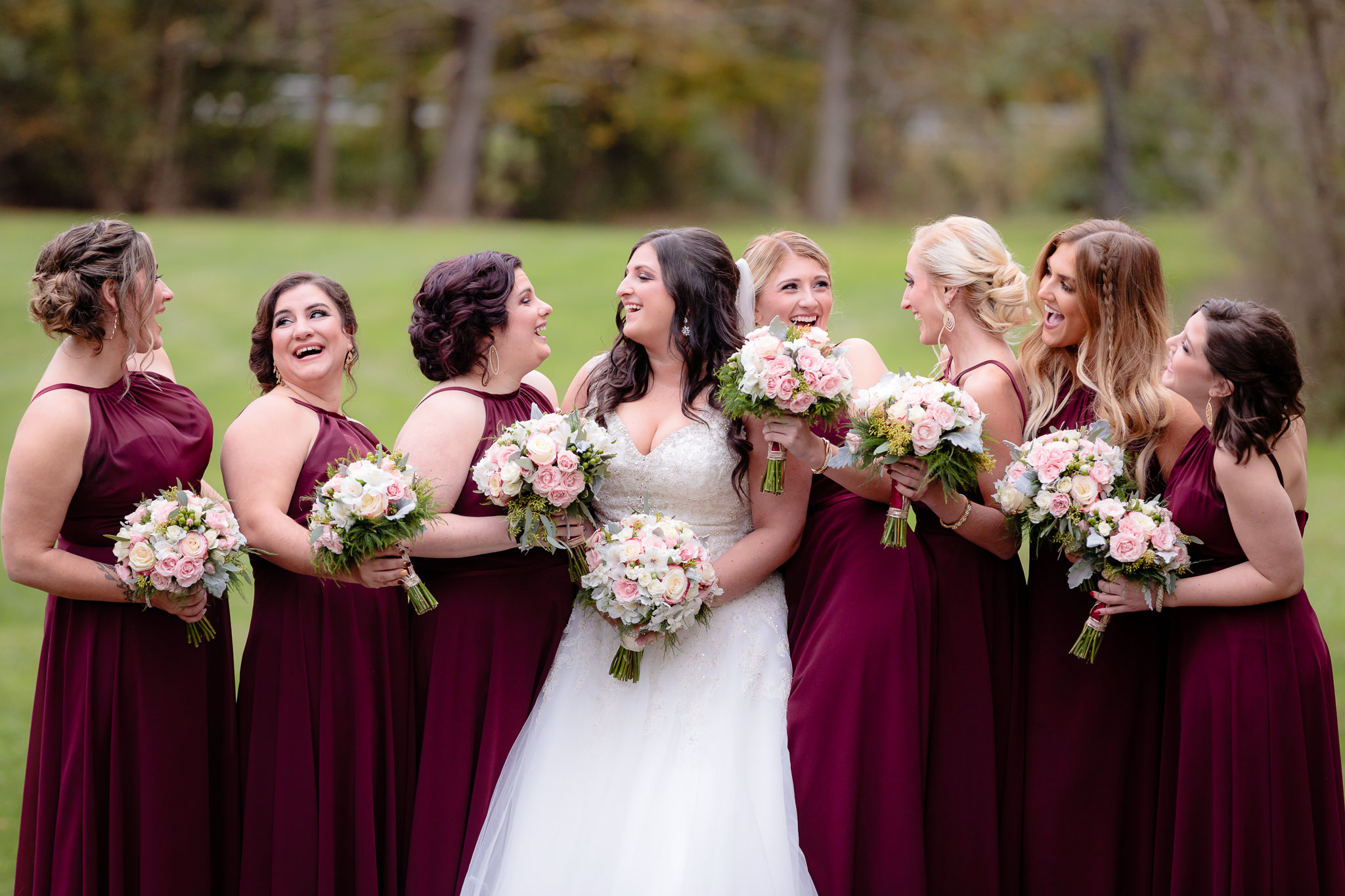Bride laughs with her bridesmaids at Olson Park