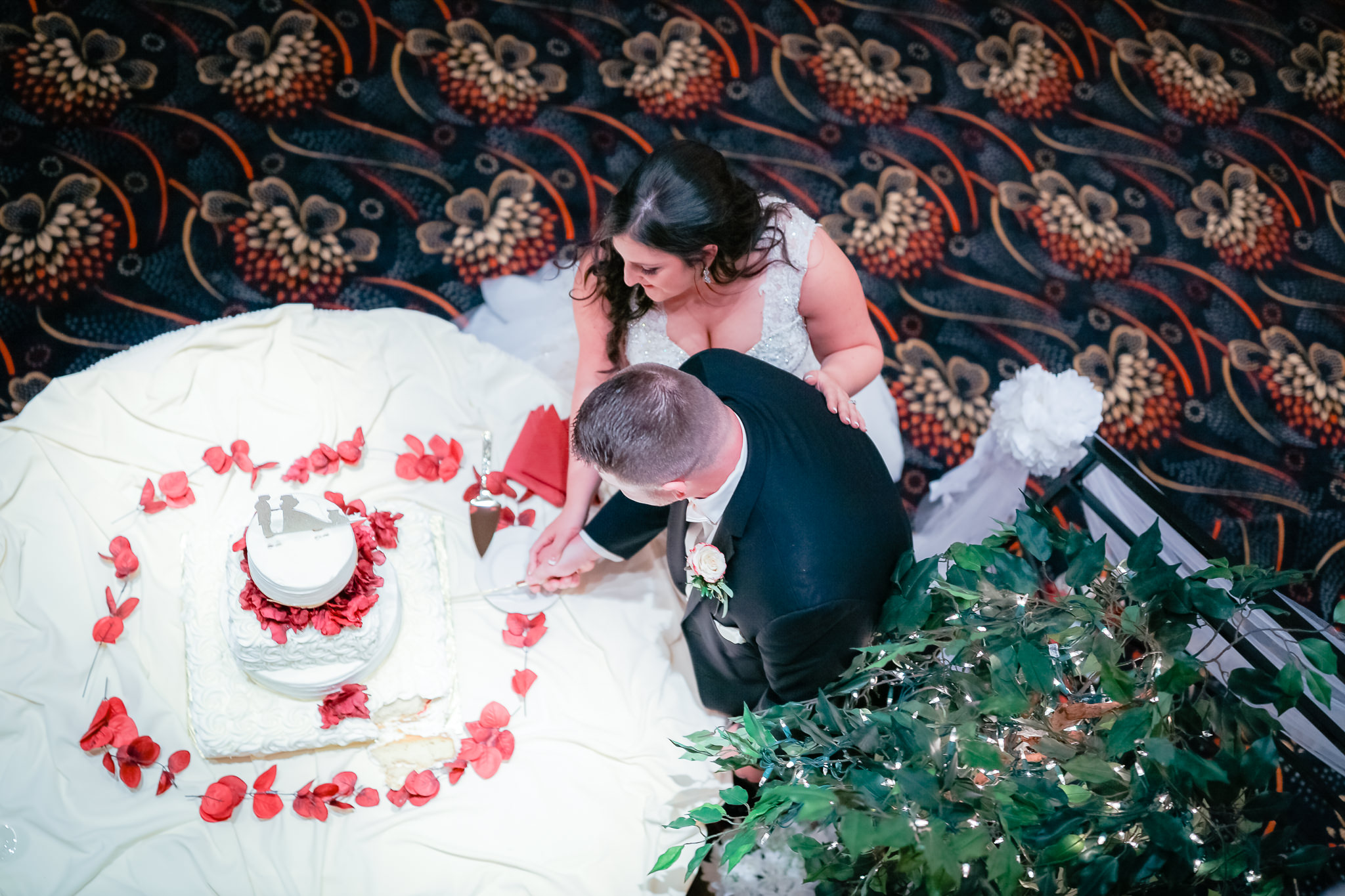 View from above of the bride and groom cutting their cake at the Fez