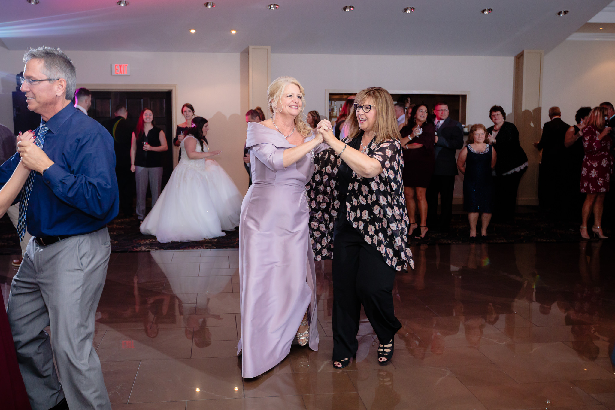 Mother of the groom dances the polka with her friend at the Fez