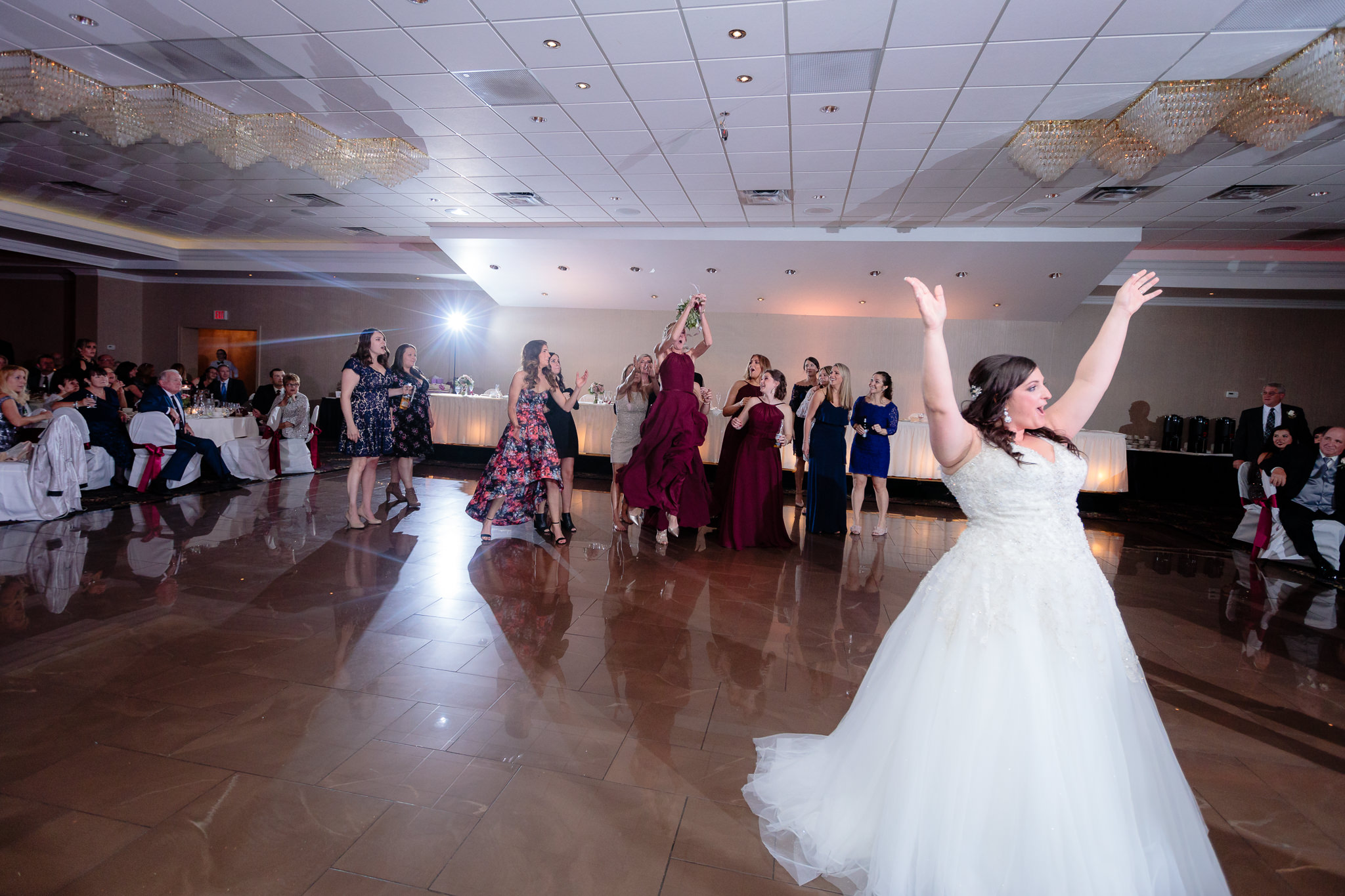 Bridesmaid jumps to catch the bouquet at the Fez