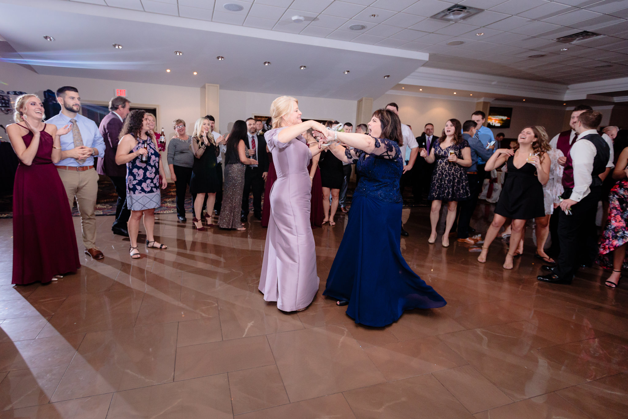 Mothers of the bride and groom dance together at a reception at the Fez