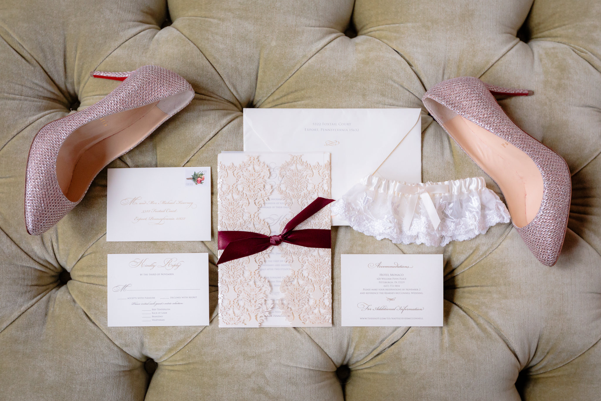 Custom invitation suite by More Than Words in Pittsburgh, PA in a flat lay with Louboutin heels