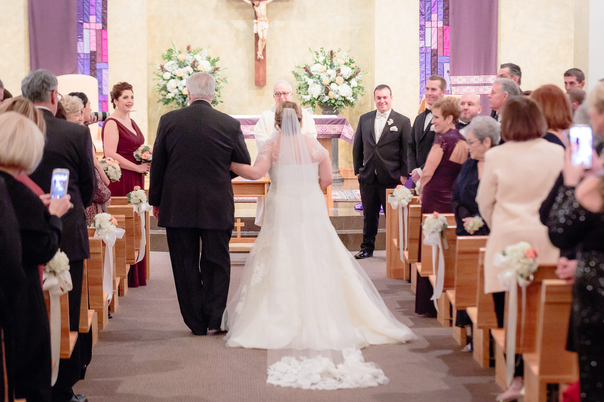 View from back of Mother of Sorrows church in Murrysville as bride walks down aisle with her father