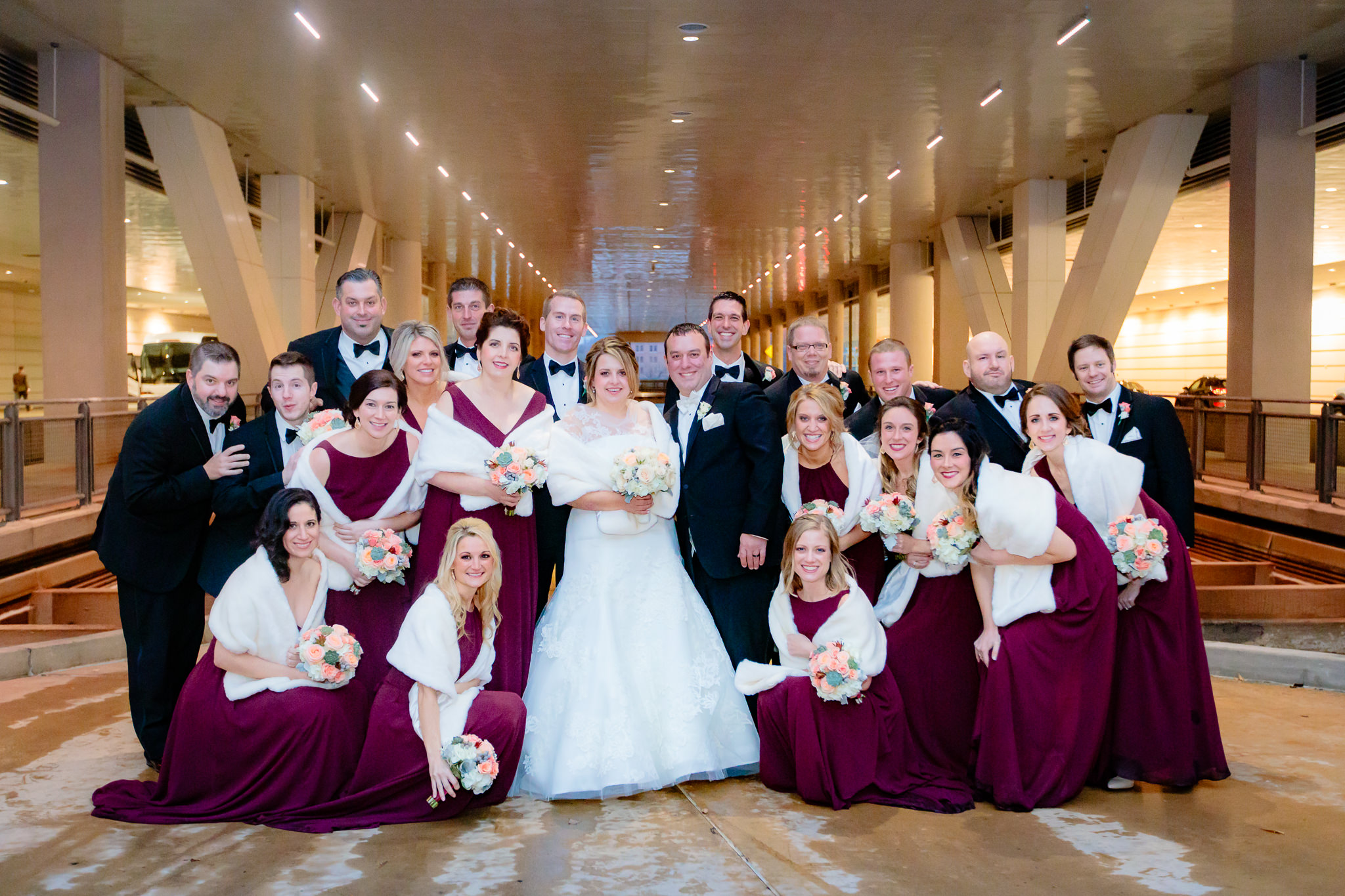 Bridal party gathers under the David L. Lawrence Convention Center in Pittsburgh for a group photo