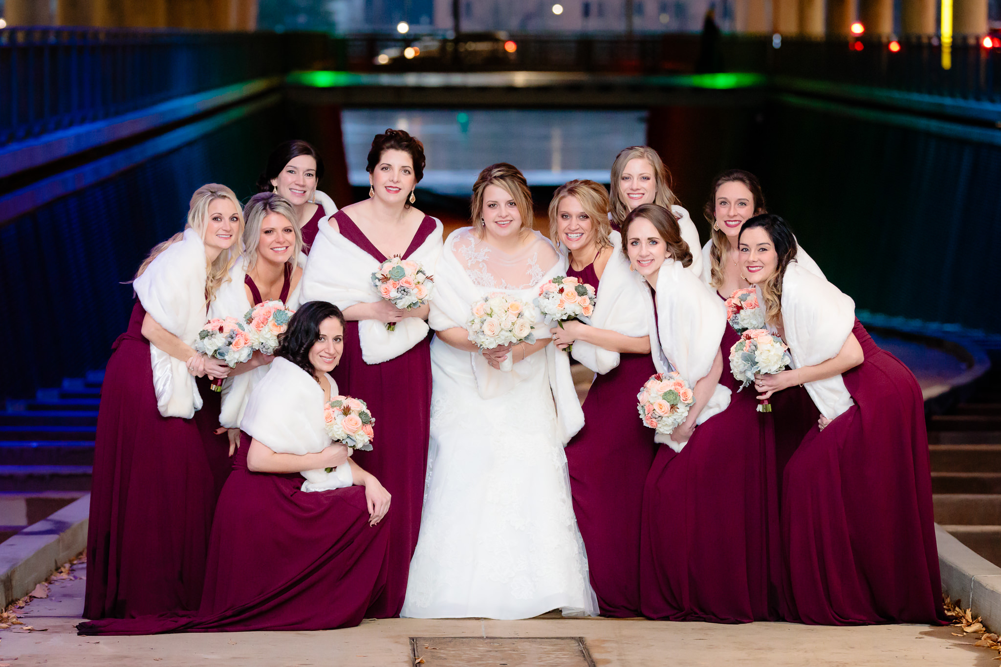 Bride huddles with her bridesmaids under the David L. Lawrence Convention Center in Pittsburgh