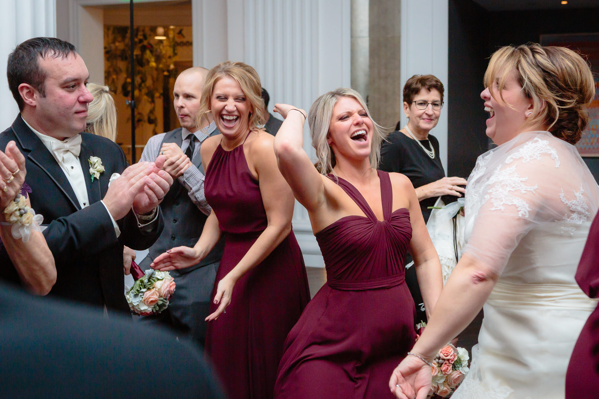 Bridesmaids dance with the bride & groom at a Pittsburgh Hotel Monaco wedding reception