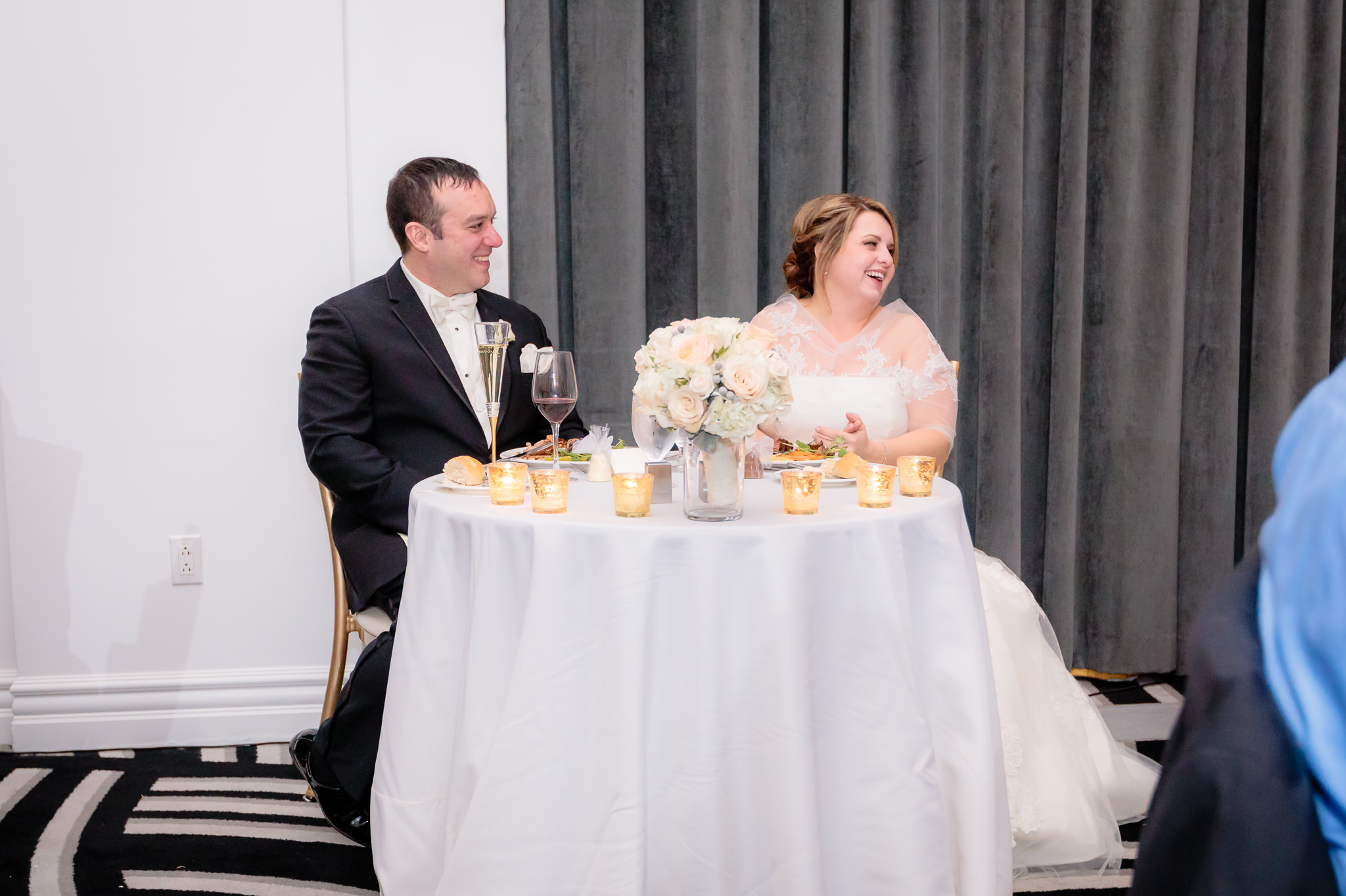 Bride & groom laugh during speeches at their Hotel Monaco reception