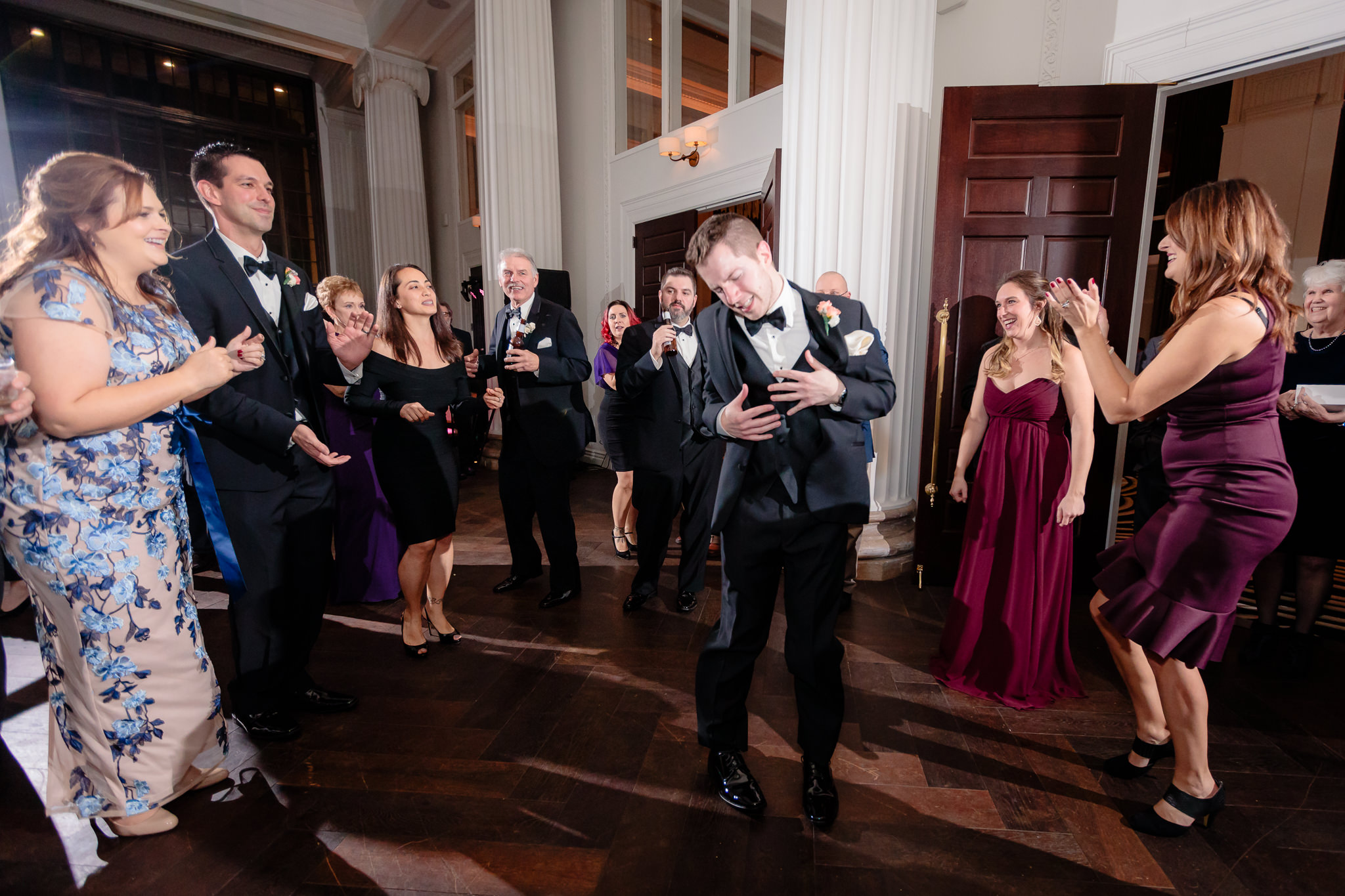 Groomsman dances at a Hotel Monaco wedding reception