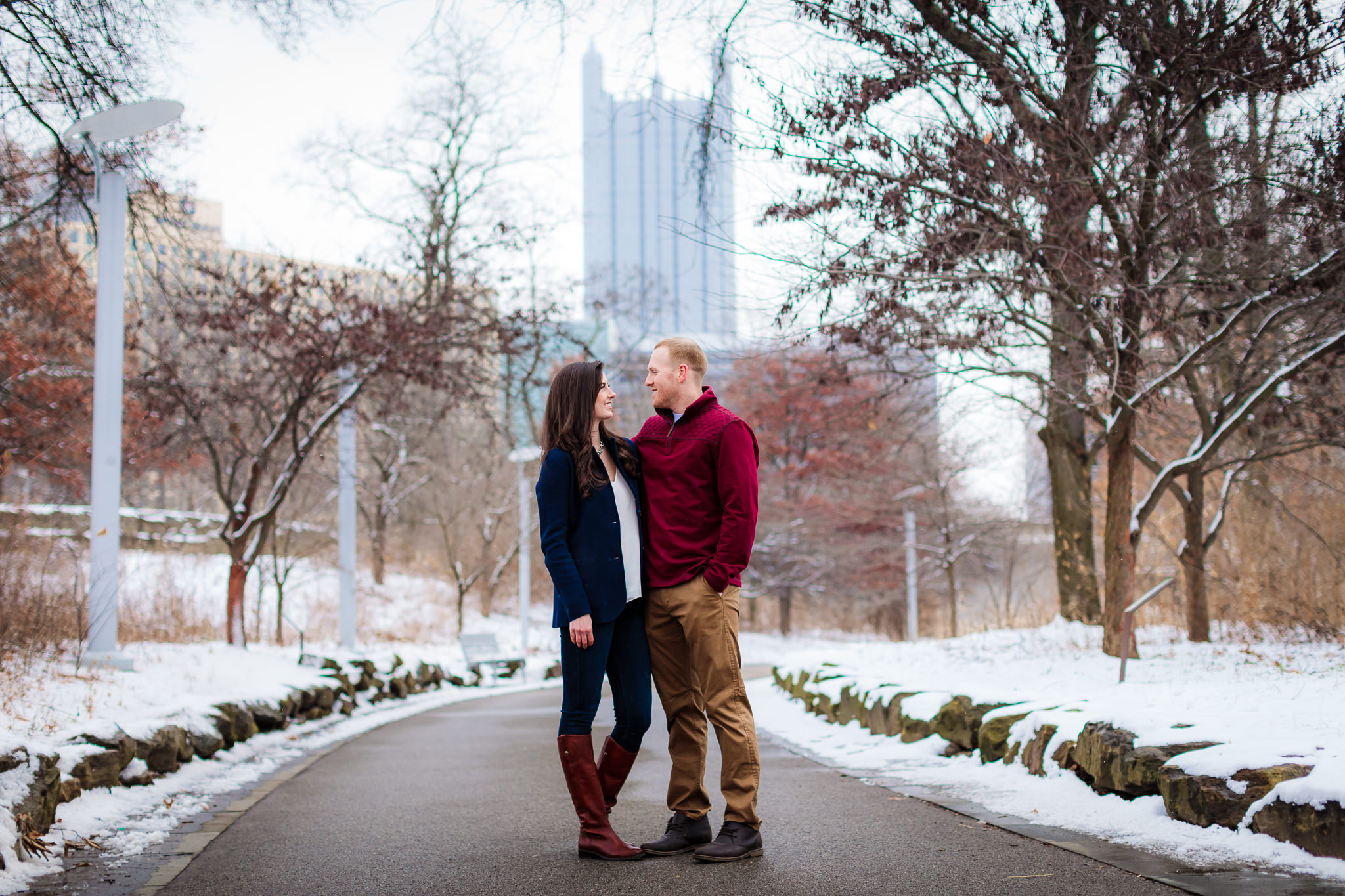 Engaged couple in front of PPG Place from Point State Park in Pittsburgh, PA