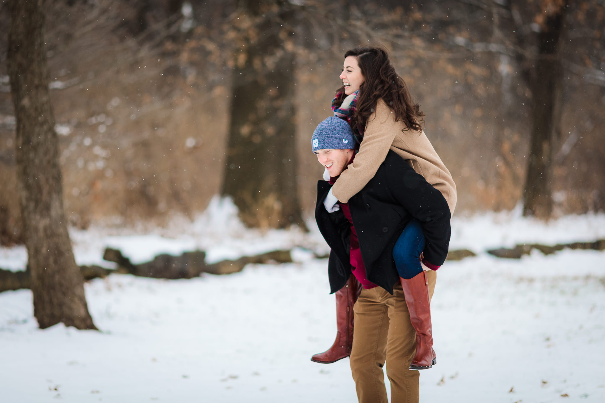 Couple plays in the snow during Point State Park engagement session