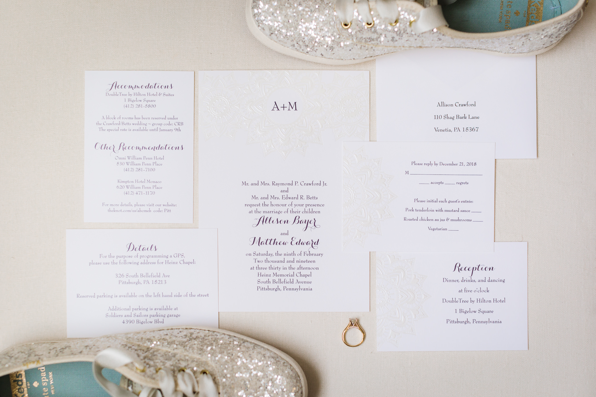 White wedding invitation suite by R. P. Crawford Company on a cream linen styling board