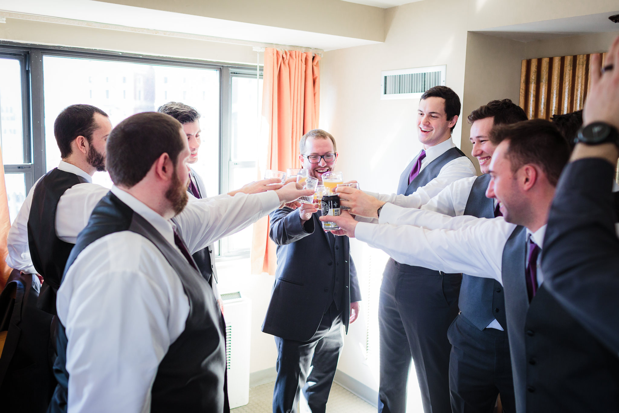 Groomsmen toast the groom at the DoubleTree Pittsburgh Downtown before his Heinz Chapel wedding
