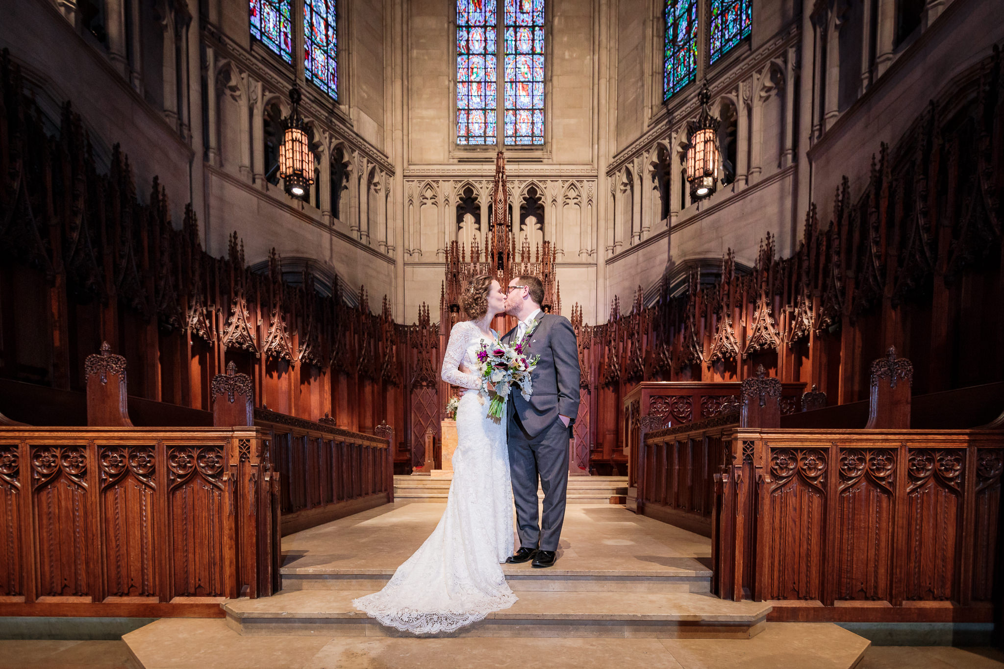 Bride & groom kiss on the altar of Heinz Chapel in Pittsburgh