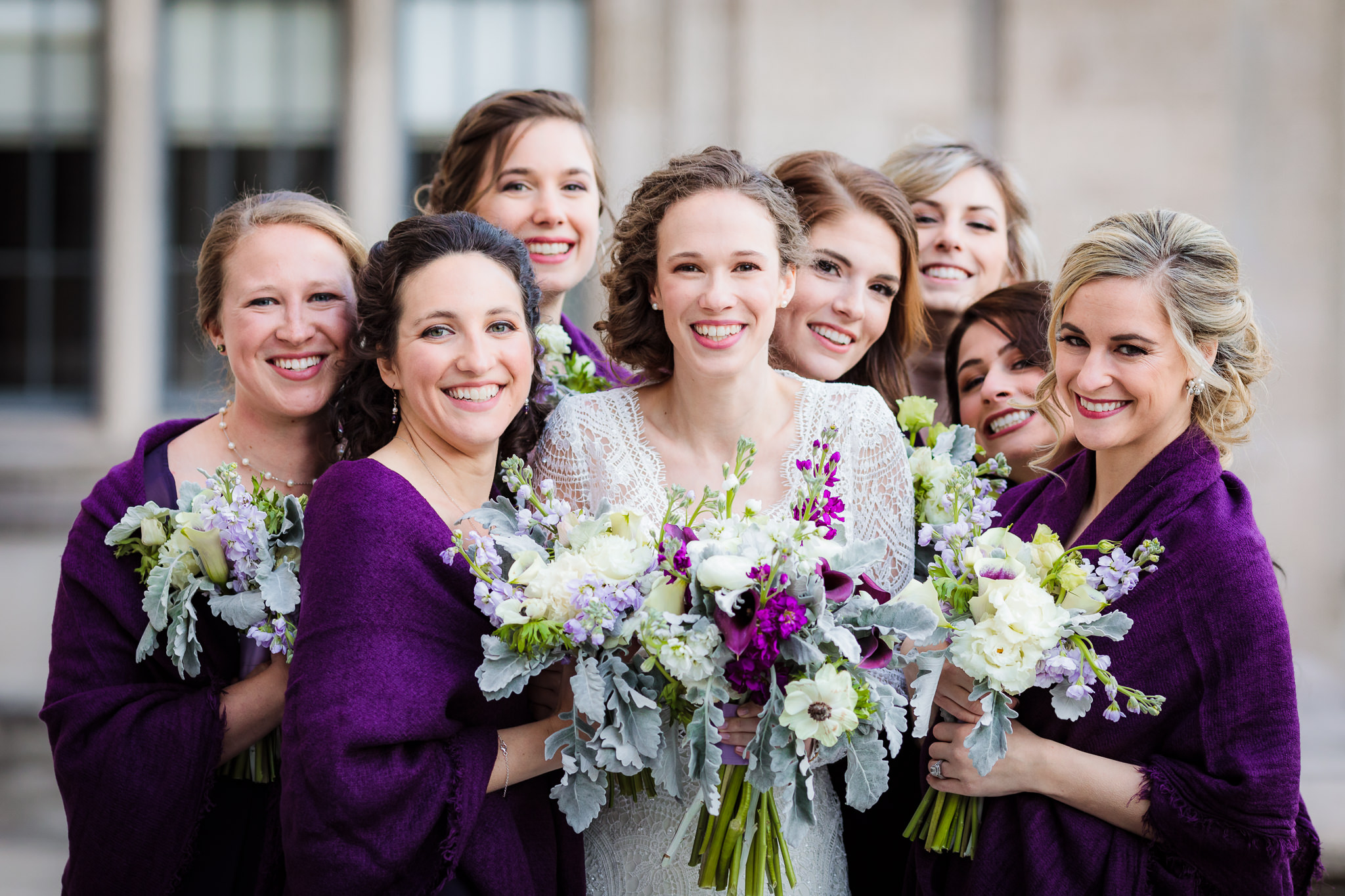 Bride & bridesmaids snuggle together in the cold weather after a Heinz Chapel wedding