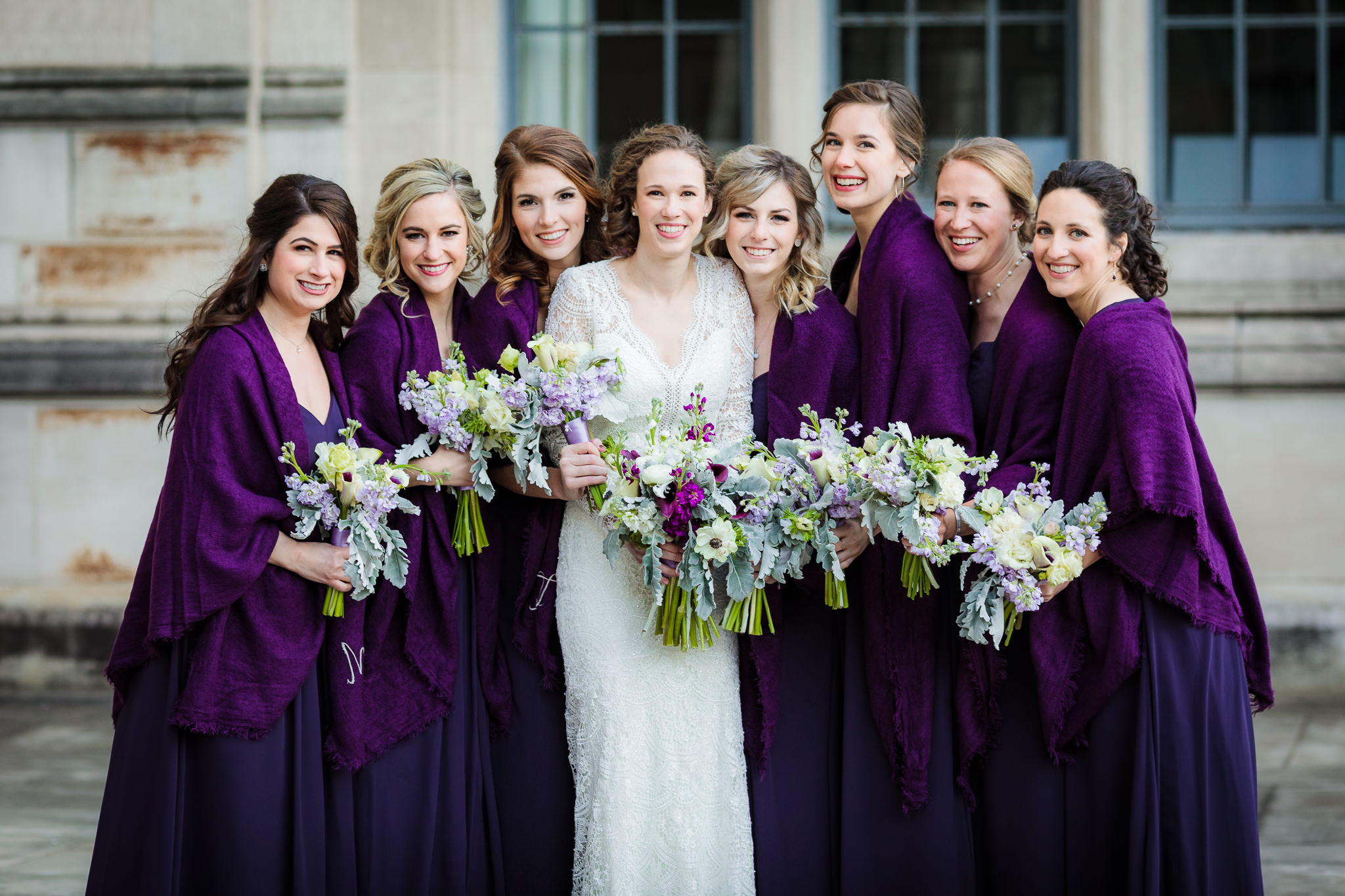 Bride with her bridesmaids in purple Bill Levkoff dresses from Bridal Beginning and flowers by Holly Hanna Floral