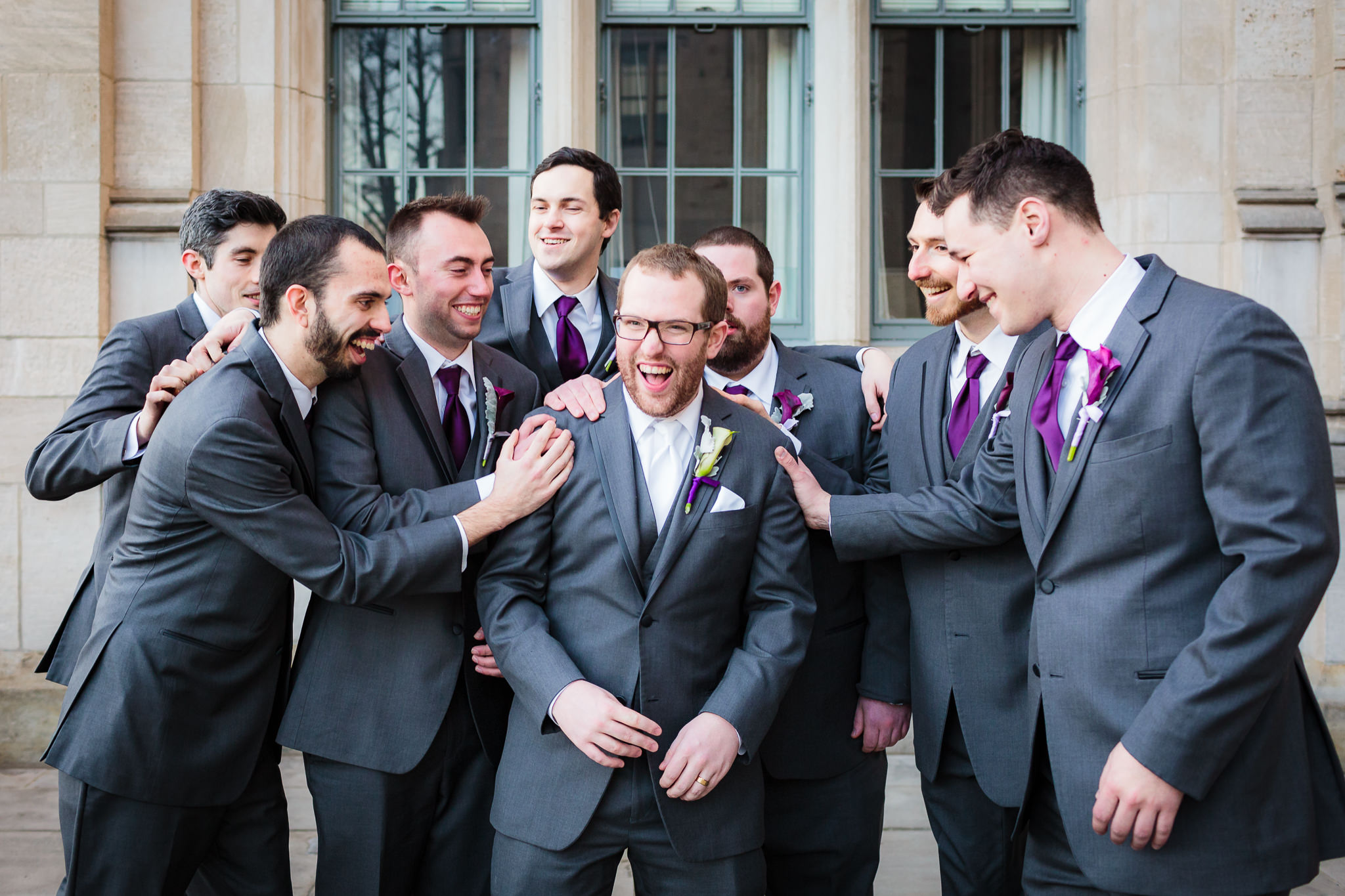 Groom laughs with his groomsmen after his Heinz Chapel wedding ceremony