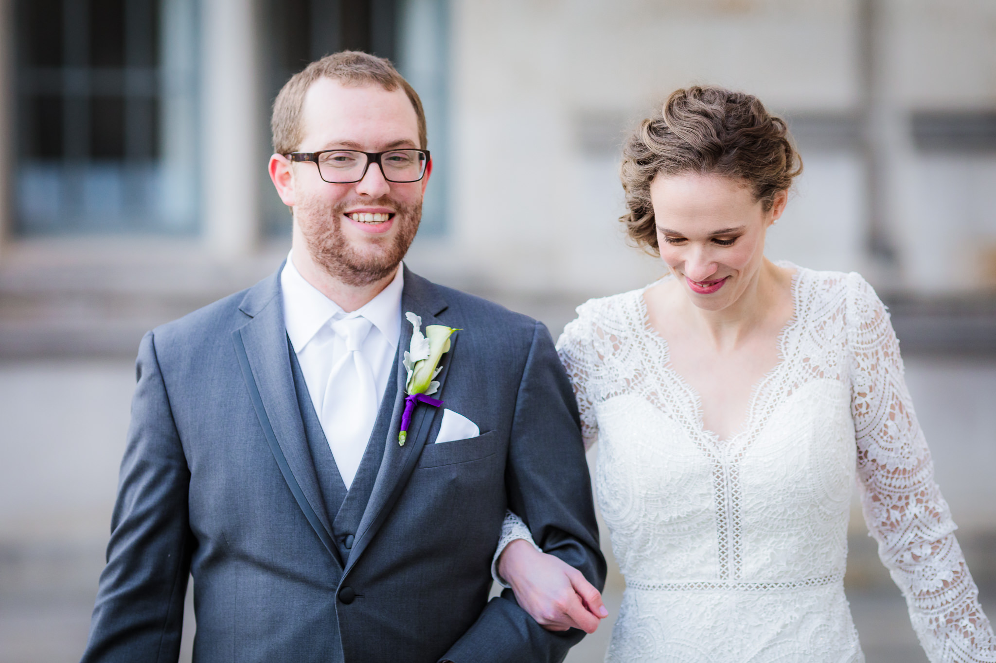 Newlyweds walk together during portraits after a Heinz Chapel wedding ceremony; Wtoo by Watters wedding dress from Bridal Beginning