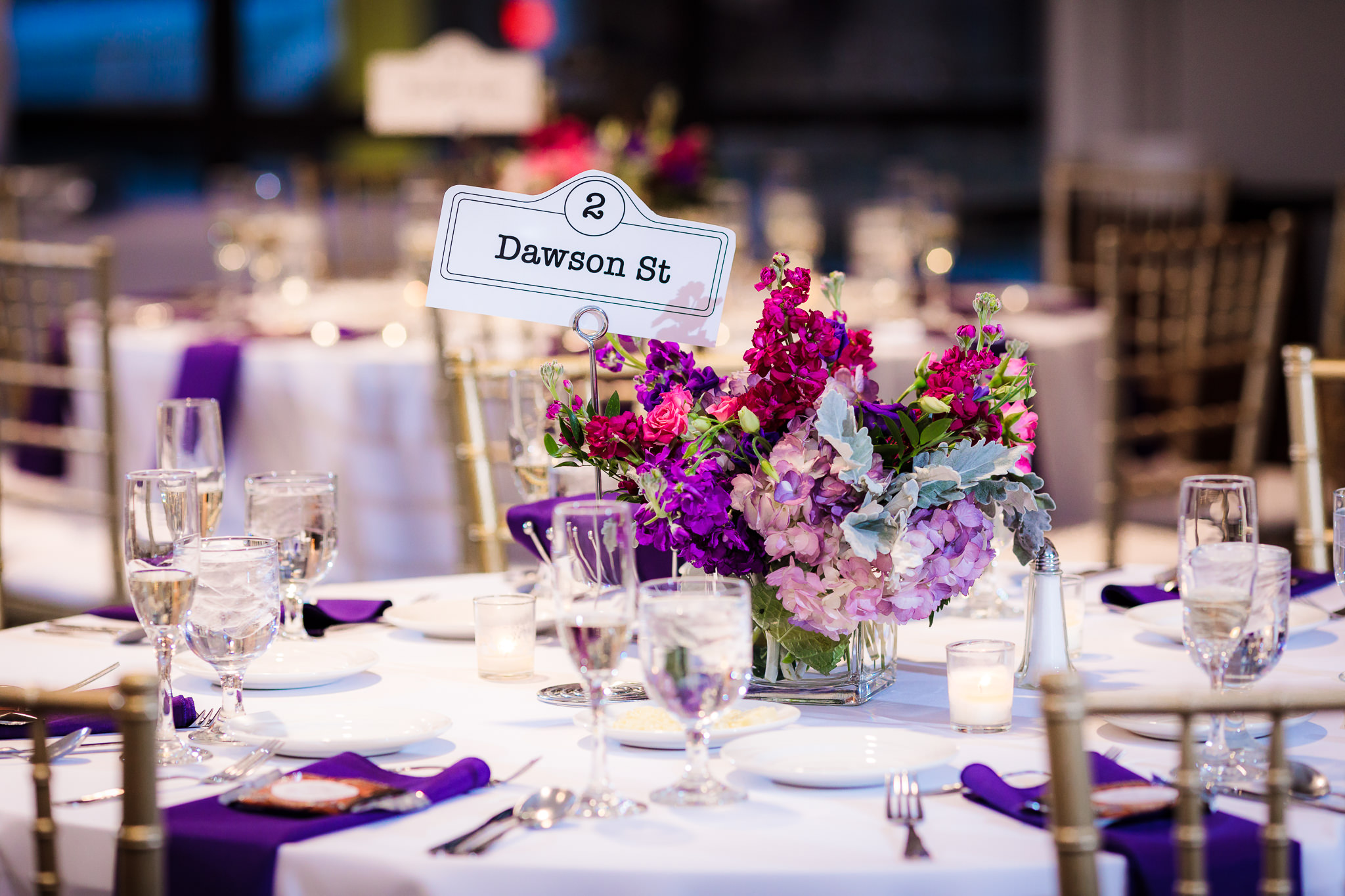 Table numbers use street names from Pittsburgh's Oakland neighborhood at a DoubleTree Pittsburgh Downtown reception; centerpieces by Holly Hanna Floral