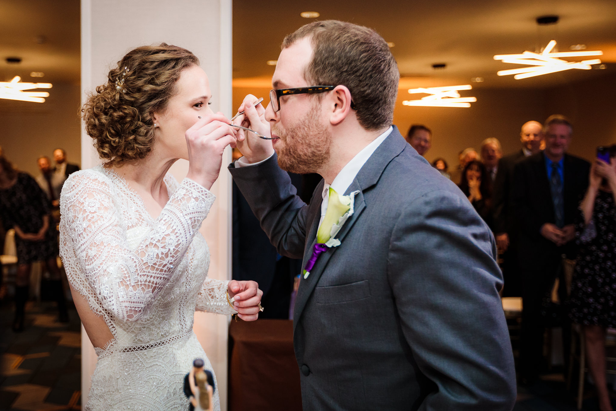 Newlyweds feed each other cake at their DoubleTree Pittsburgh Downtown wedding