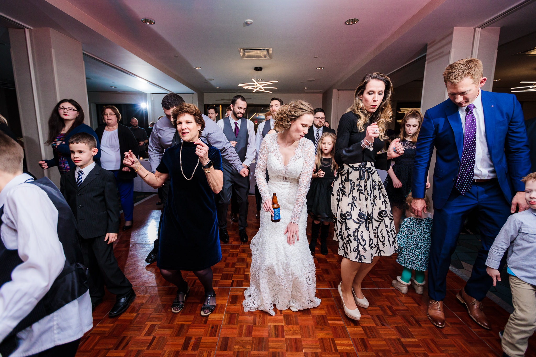 Bride dances with guests at her DoubleTree Pittsburgh Downtown wedding reception