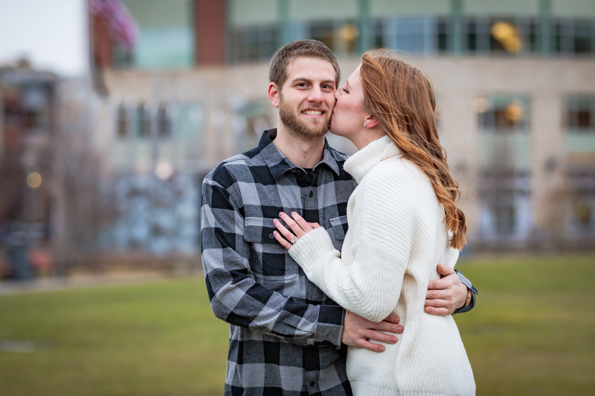 Bride-to-be kisses her fiance's cheek during a North Shore engagement session in Pittsburgh, PA