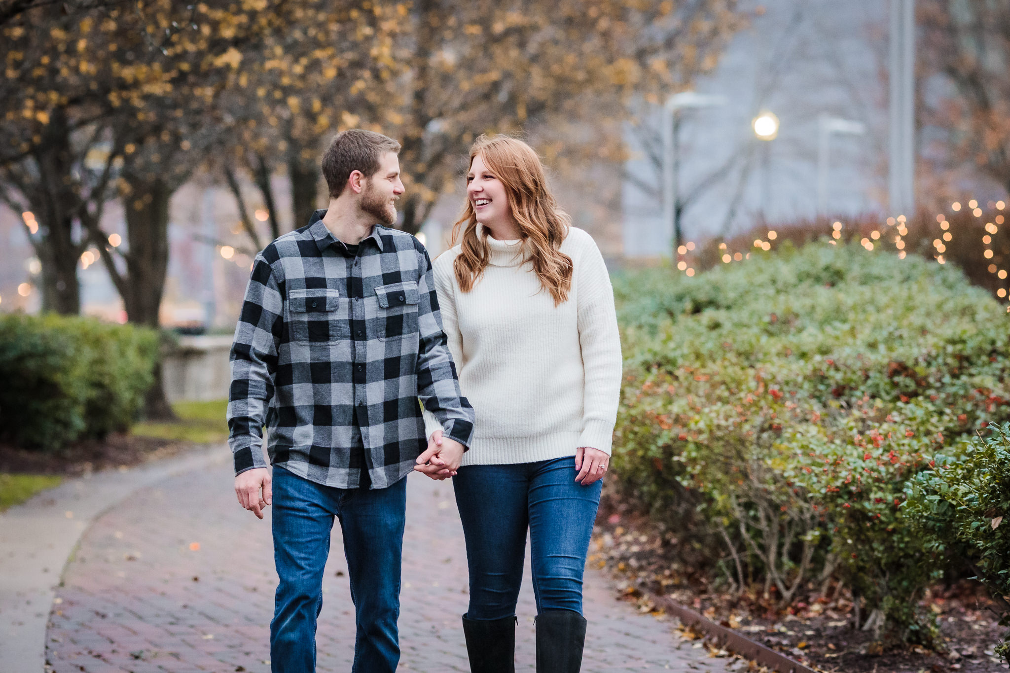 Couple laughs while walking during their North Shore engagement session