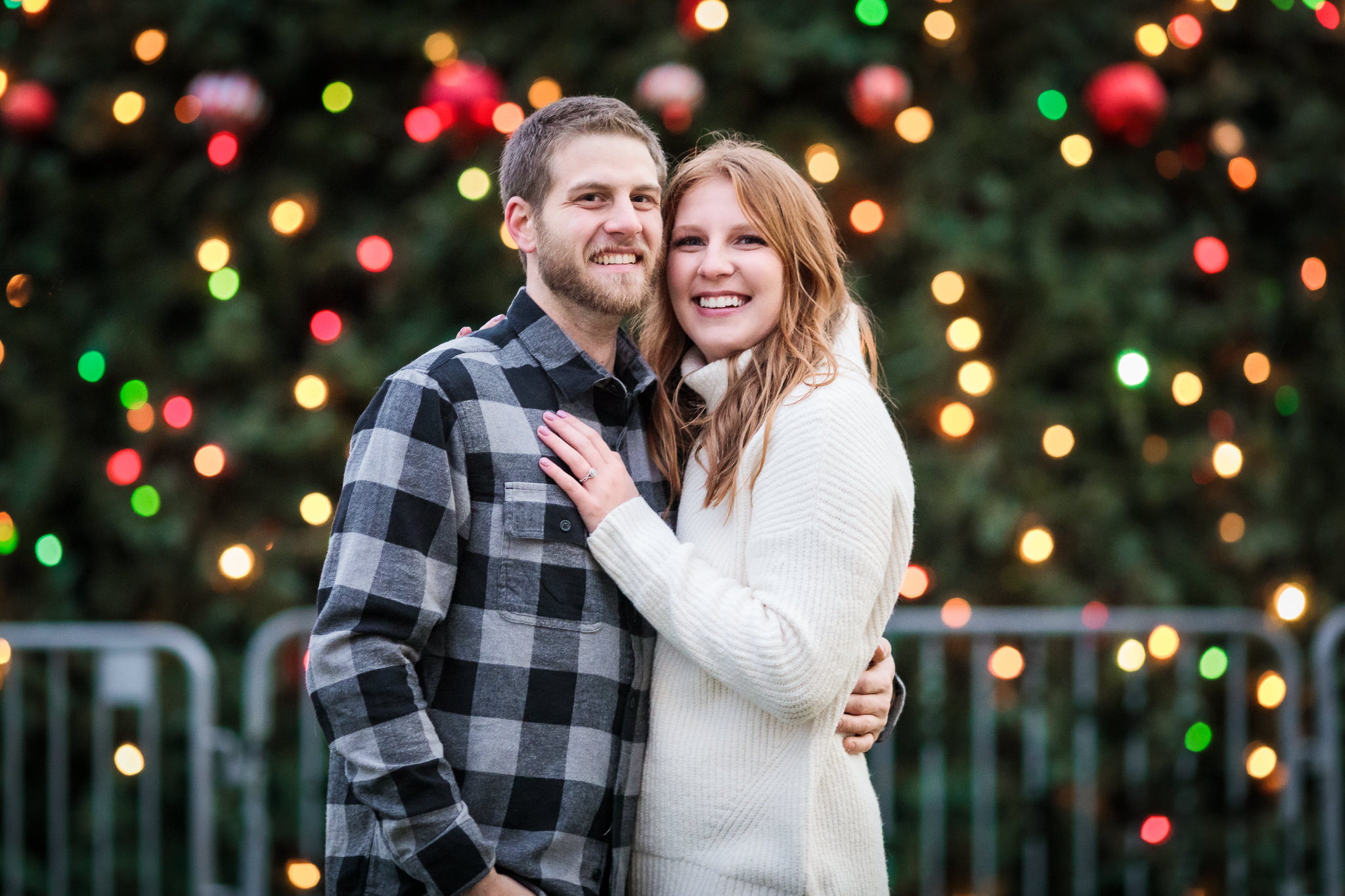 Couple in front of Christmas tree at a North Shore engagement session
